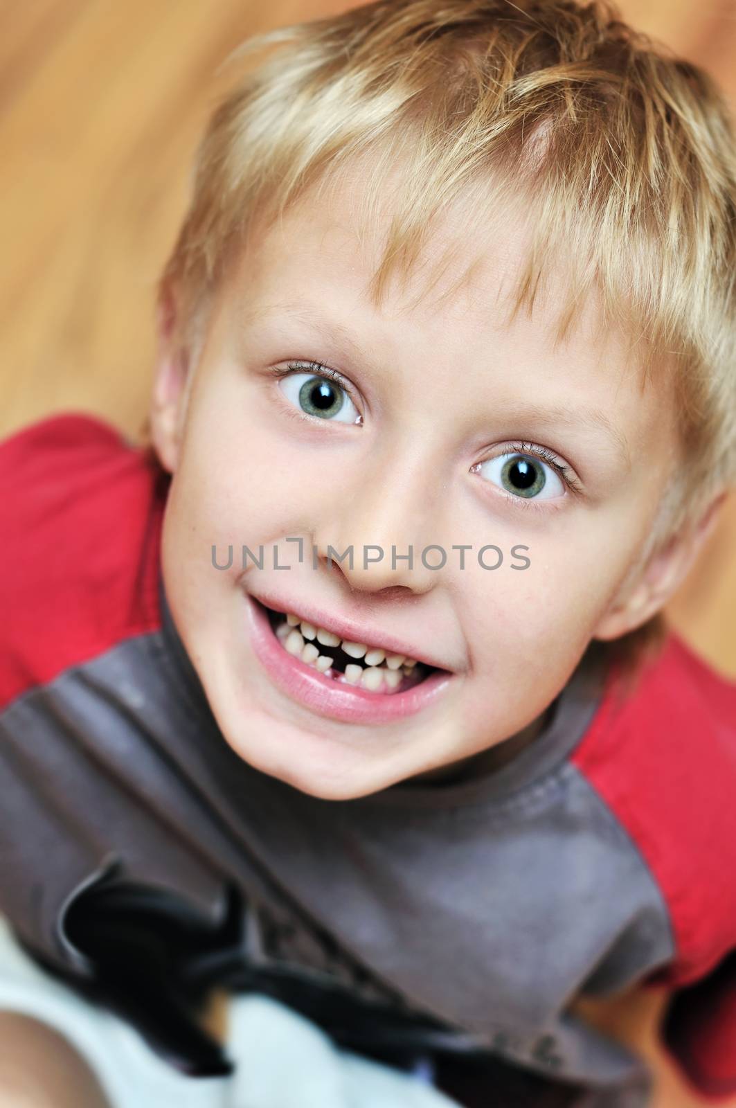 little boy showing that he lost first milk tooth 