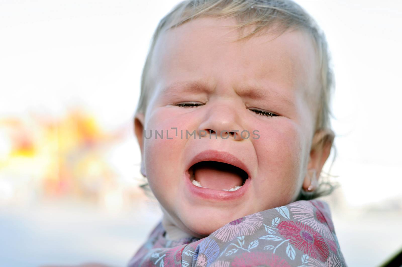 portrait of crying baby girl with sad face