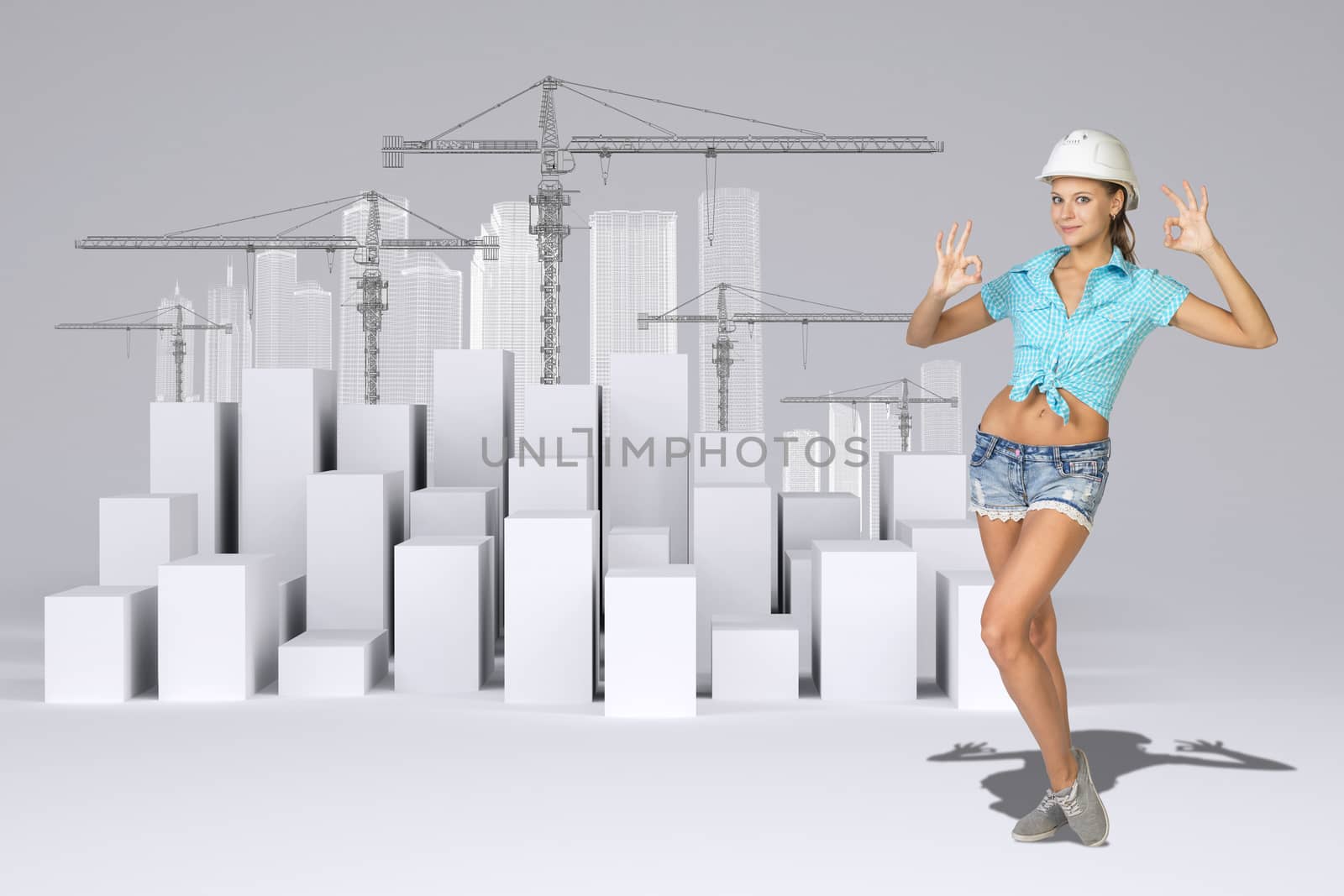 Beautiful girl in working clothes showing hand signs, looking at camera, smiling. Minimalistic city of white cubes with wire-frame buildings and tower cranes on gray background