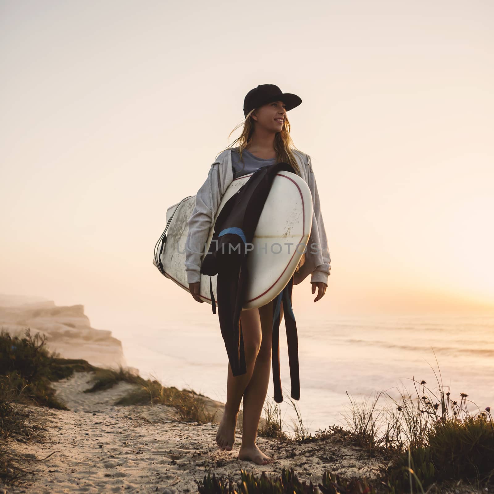 Beautiful female Surfer looking for the waves