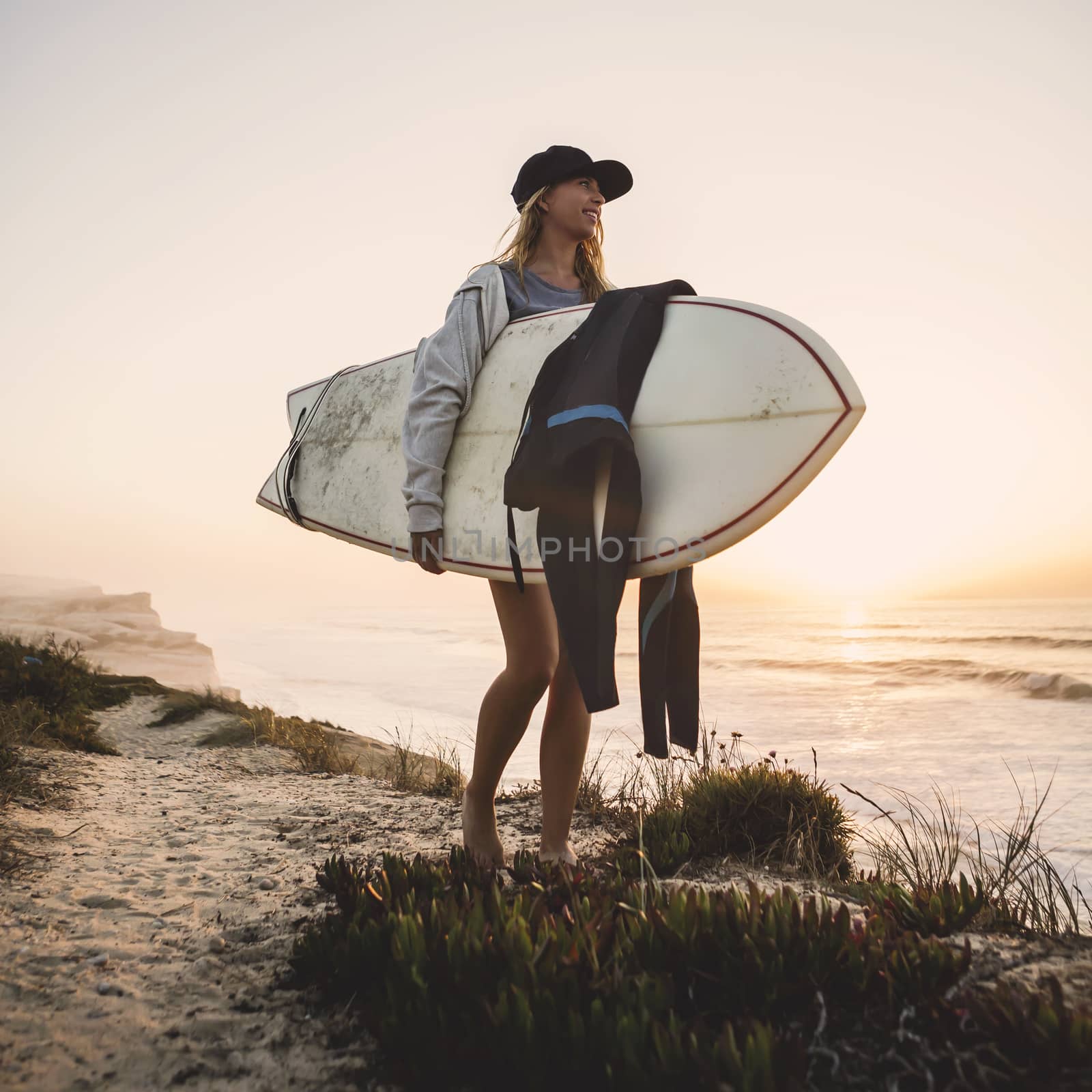 Beautiful female Surfer looking for the waves