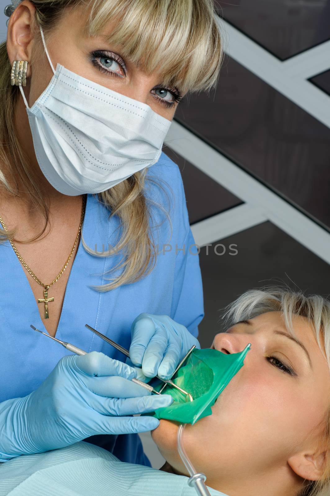 dentist at work with patient, exam, cleaning, curing, using dental water jet