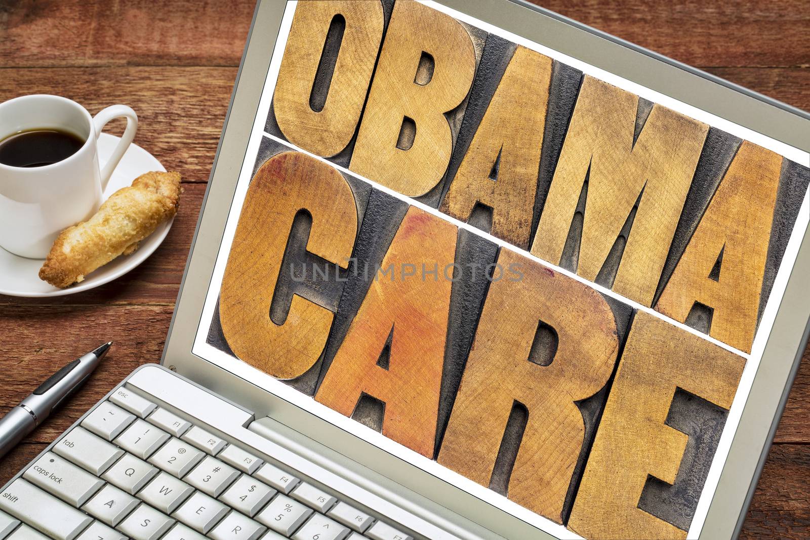 obamacare typography - word abstract in letterpress woodtype on a laptop screen