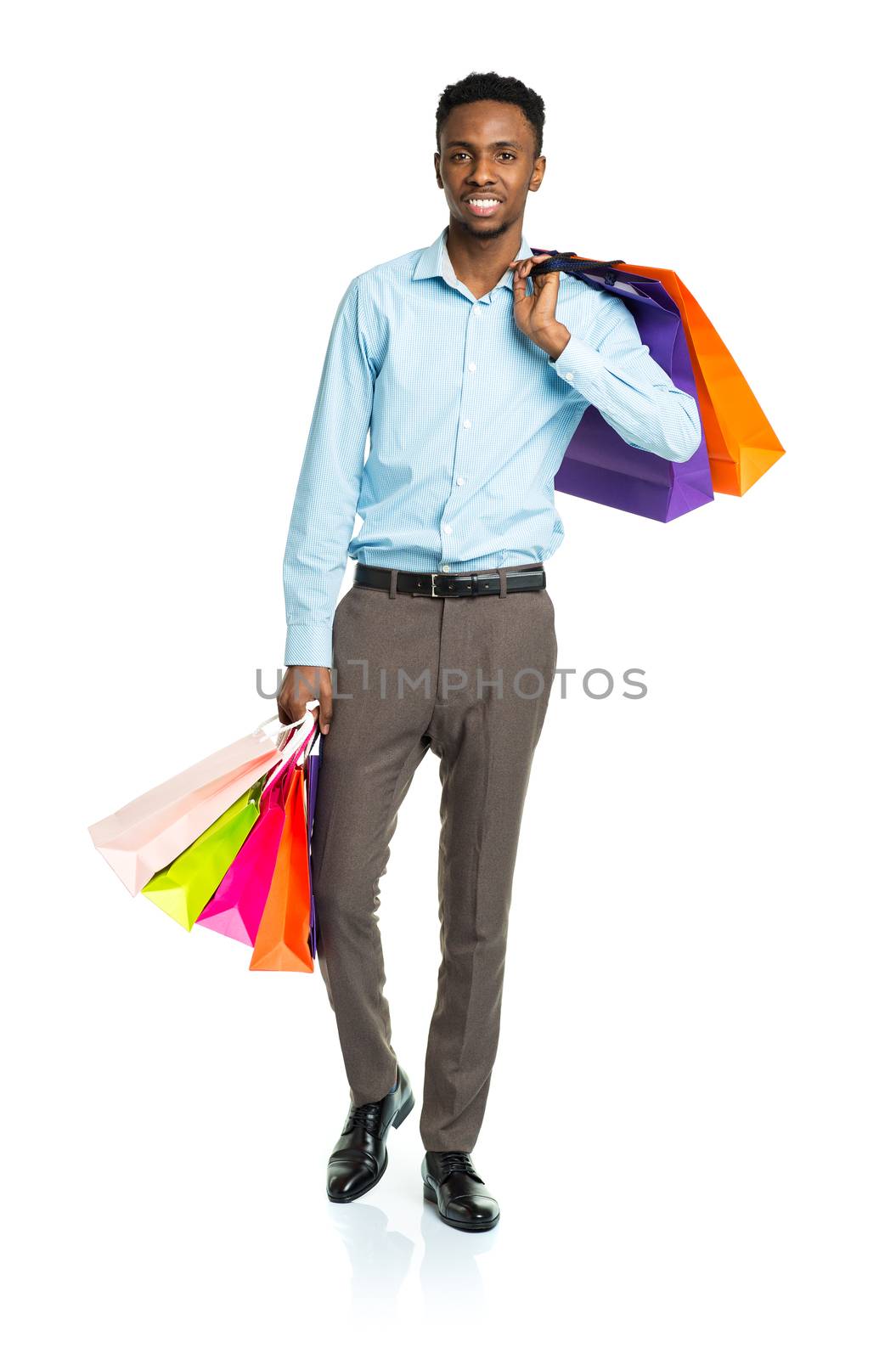 Happy african american man holding shopping bags on white background. Shoppind