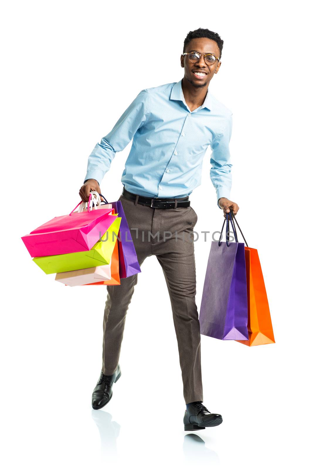 Happy african american man holding shopping bags on white background. Shoppind