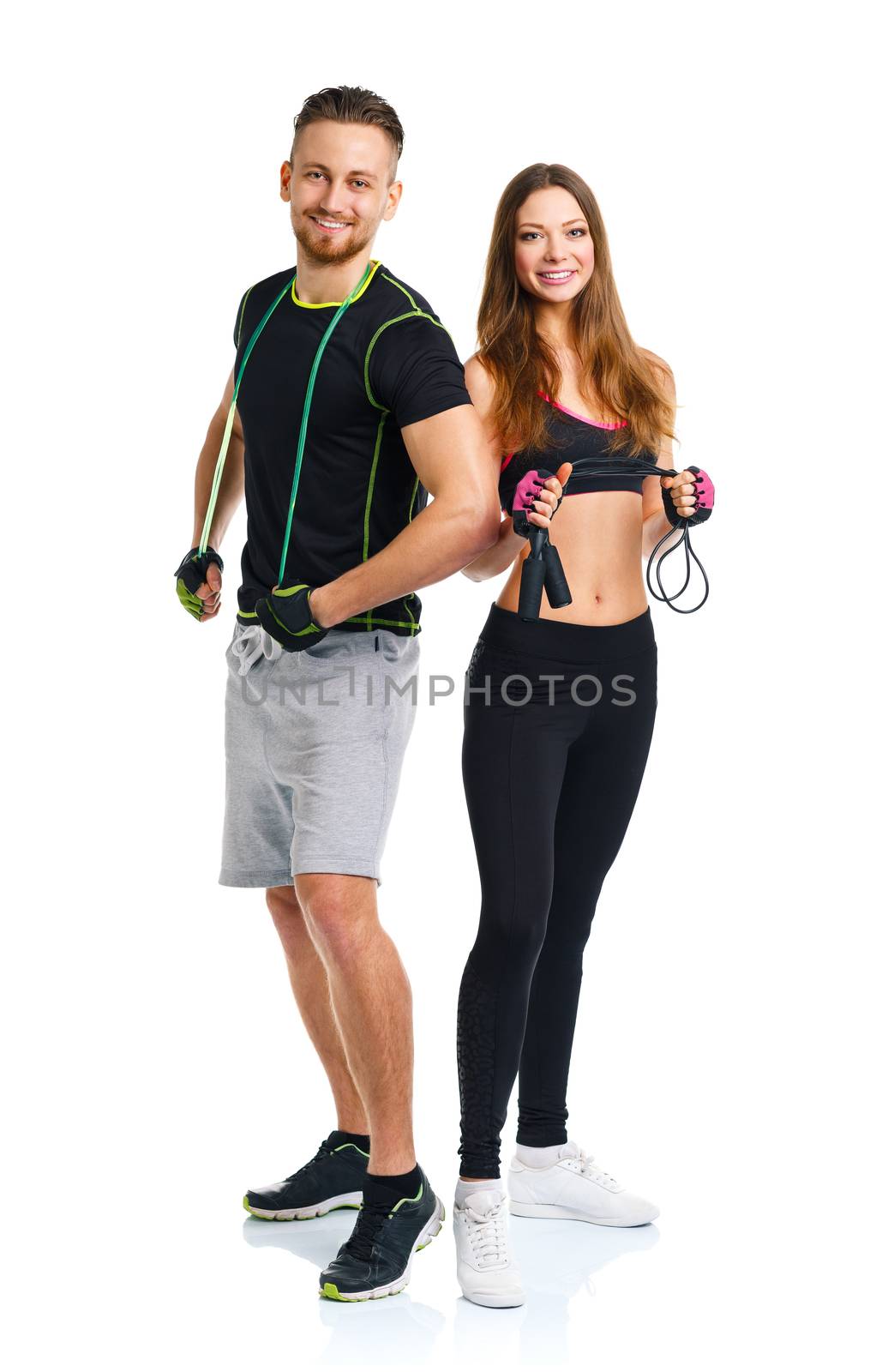 Happy athletic couple - man and woman with with ropes on the white background