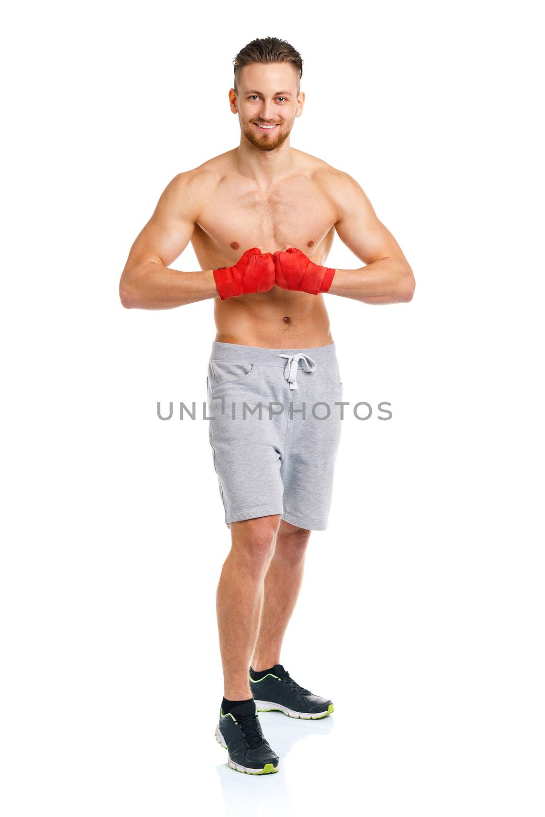 Athletic attractive man wearing boxing bandages on the white by vlad_star