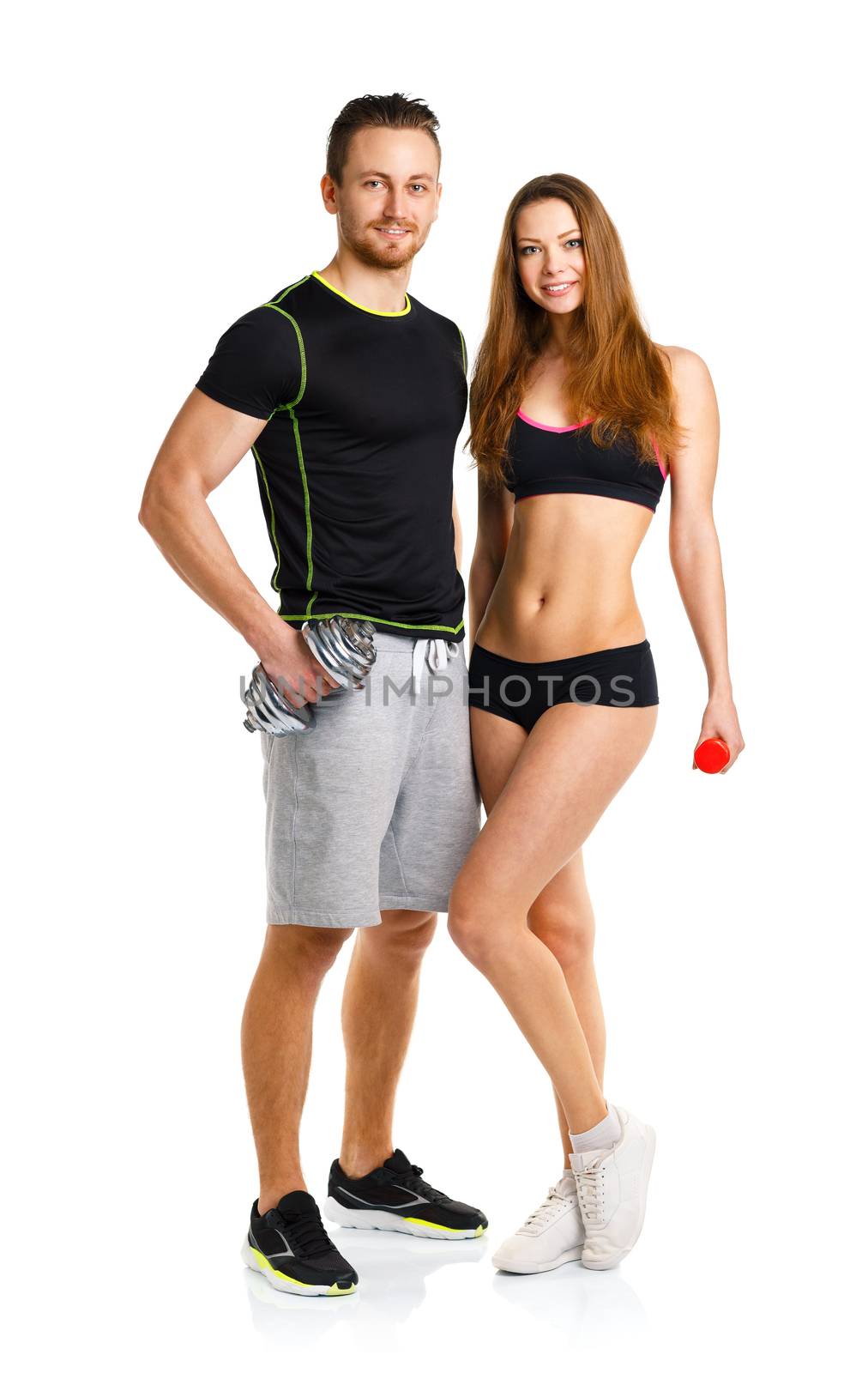 Sport couple - man and woman with dumbbells on the white background