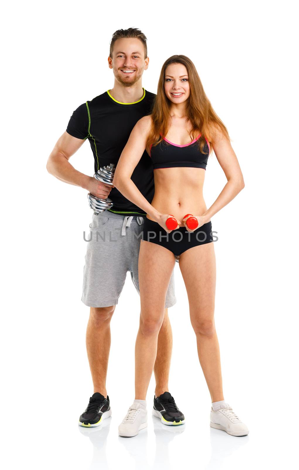 Sport couple - man and woman with dumbbells on the white background