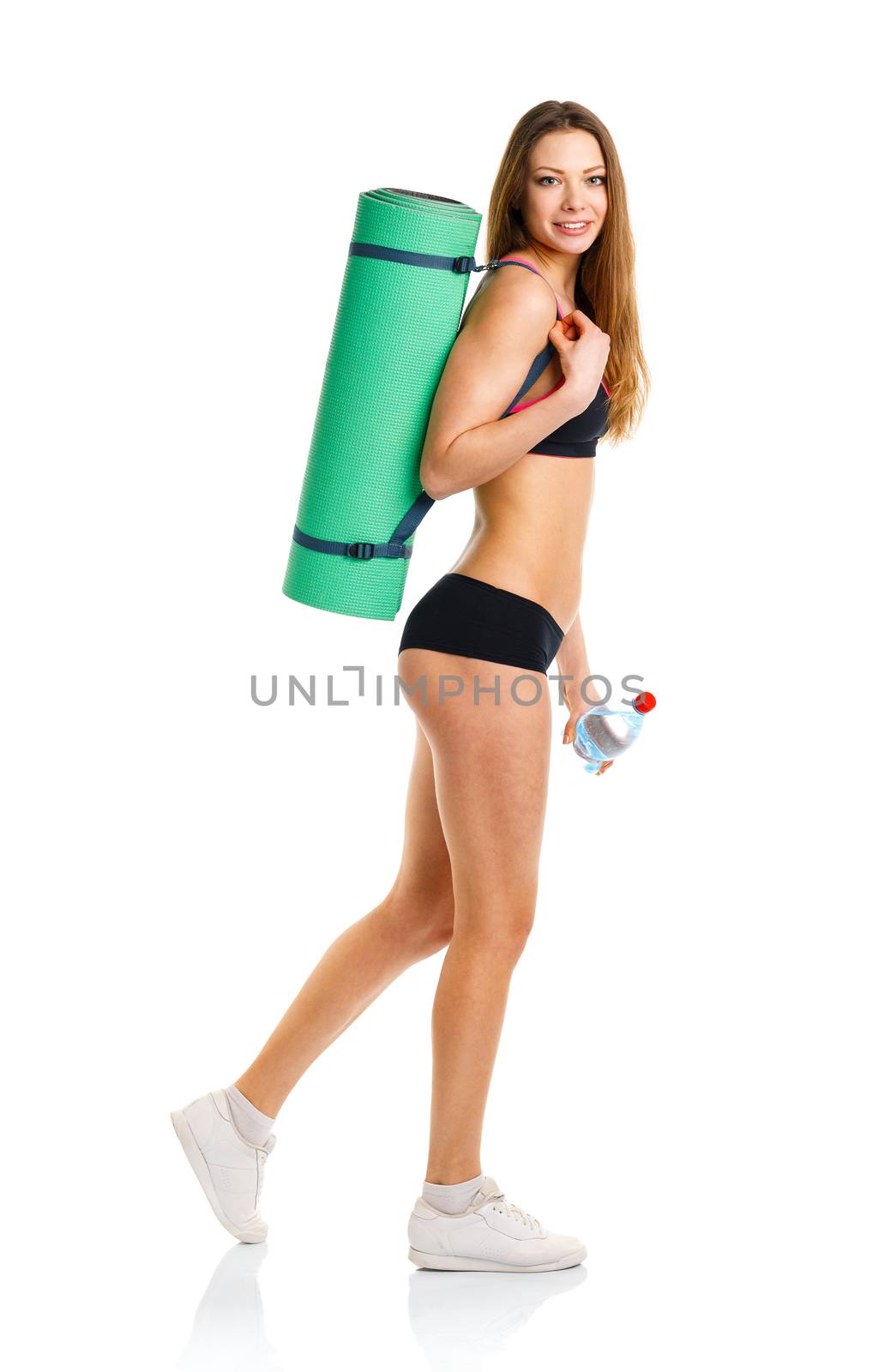 Beautiful athletic woman with mat for fitness and bottle of wate by vlad_star