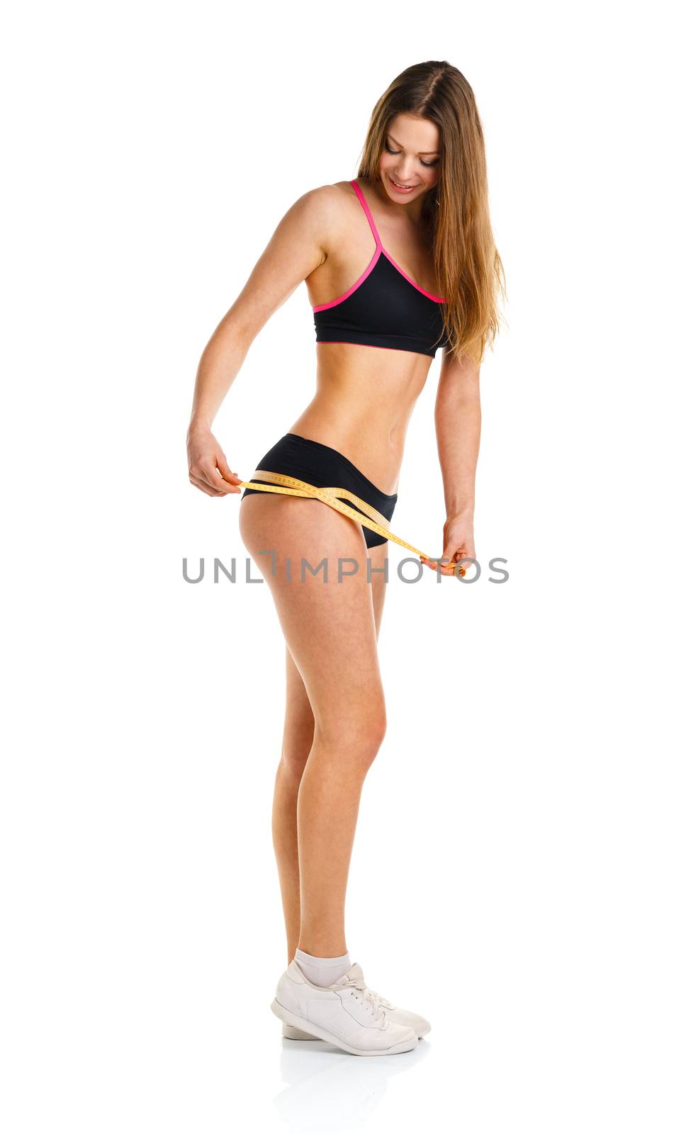 Happy athletic woman measuring perfect shape of beautiful thigh, healthy lifestyles concept