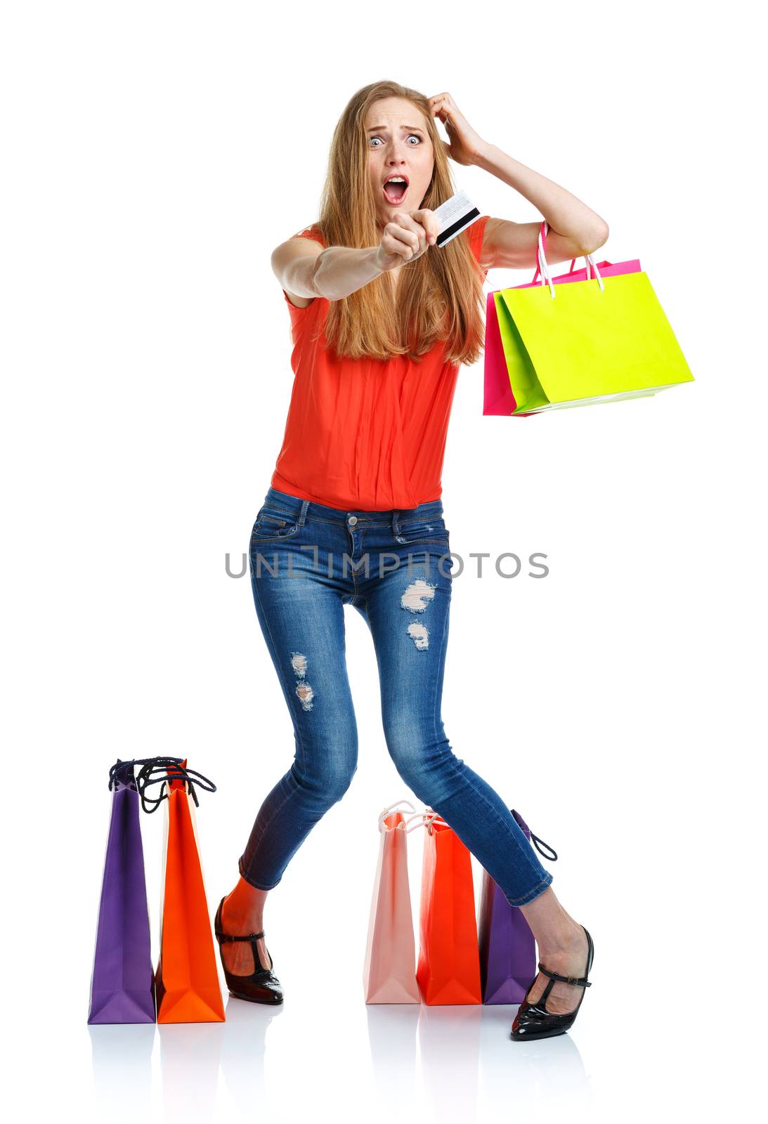 Happy lovely woman with shopping bags and credit card over white background