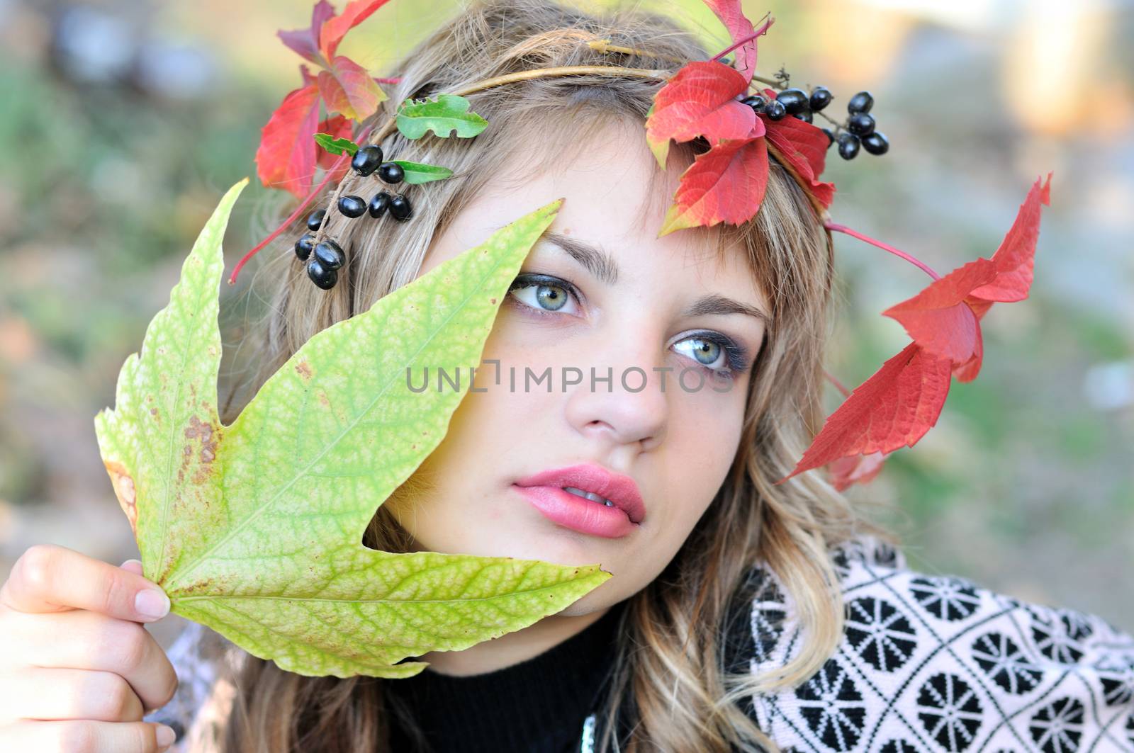 face of tender girl wearing autumn crown 