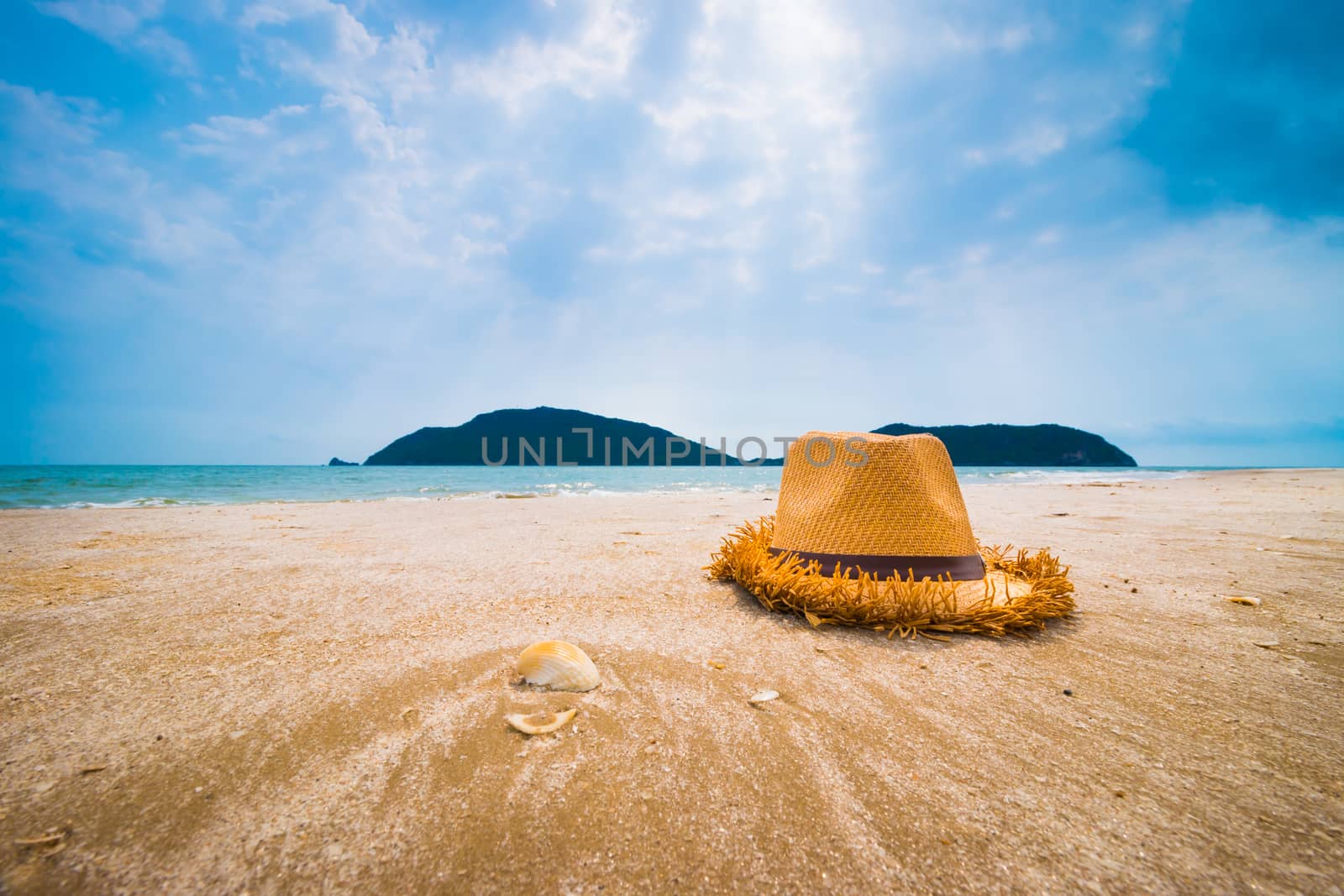 Hat and Shell on tropical beach