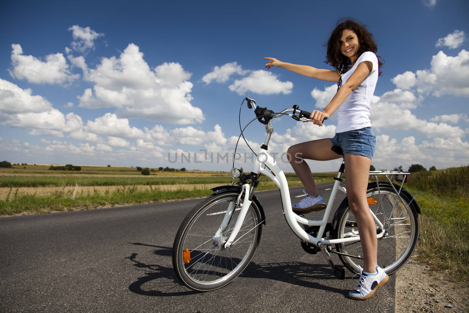 Girl riding her bike, summer free time spending by JanPietruszka