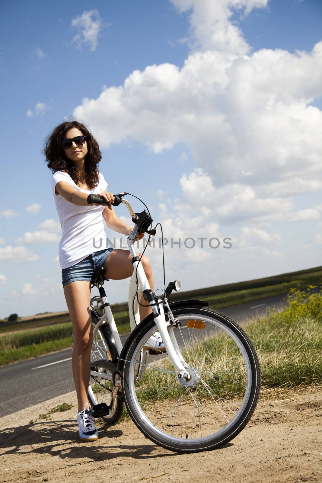 Woman riding bicycle, summer free time spending