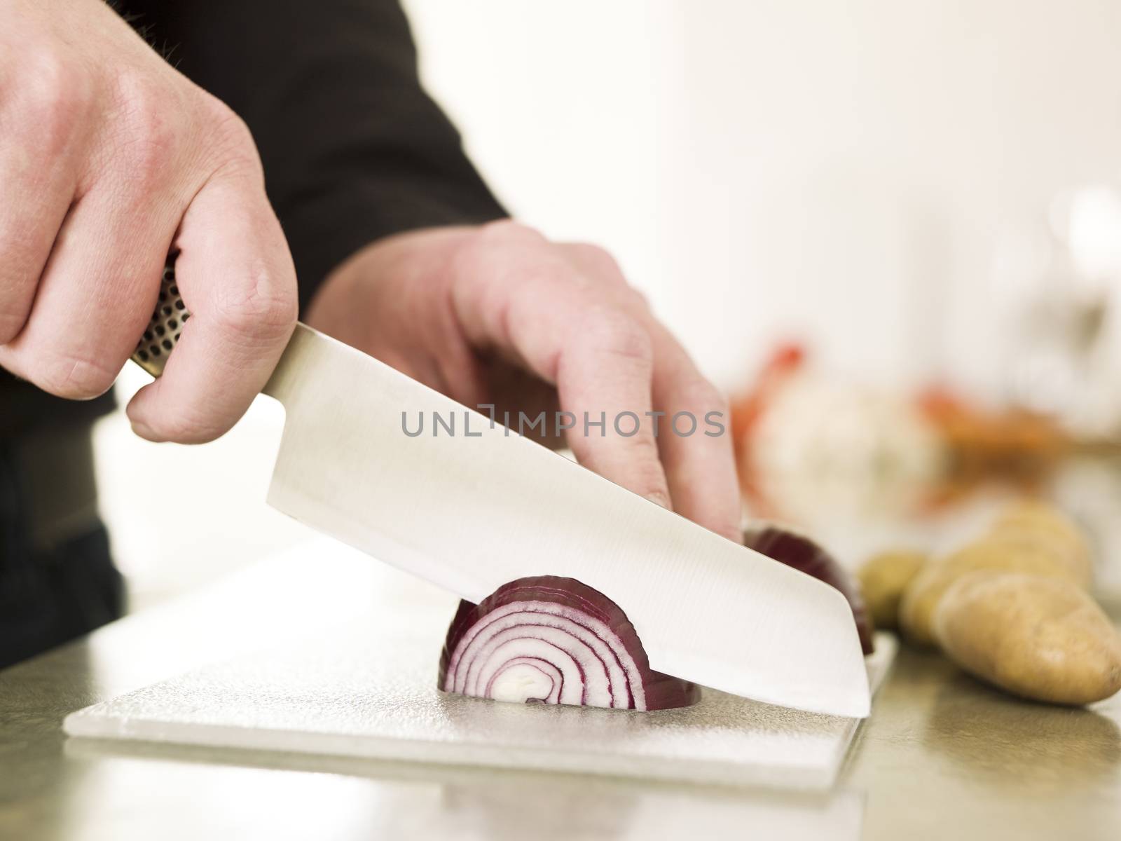 Close up of a man Cutting onion with knife
