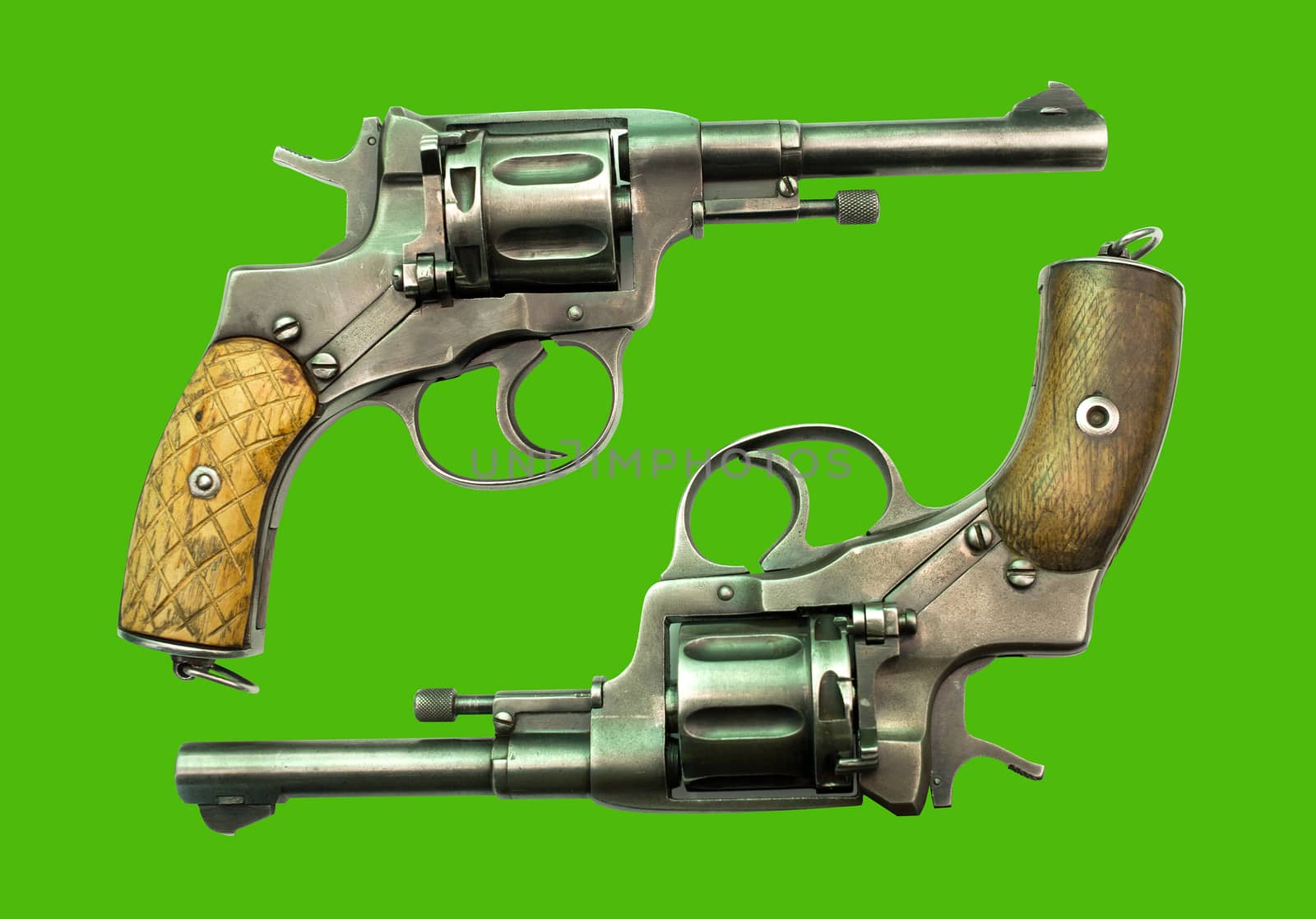 Old weapons: two Revolver Nagan on a green background