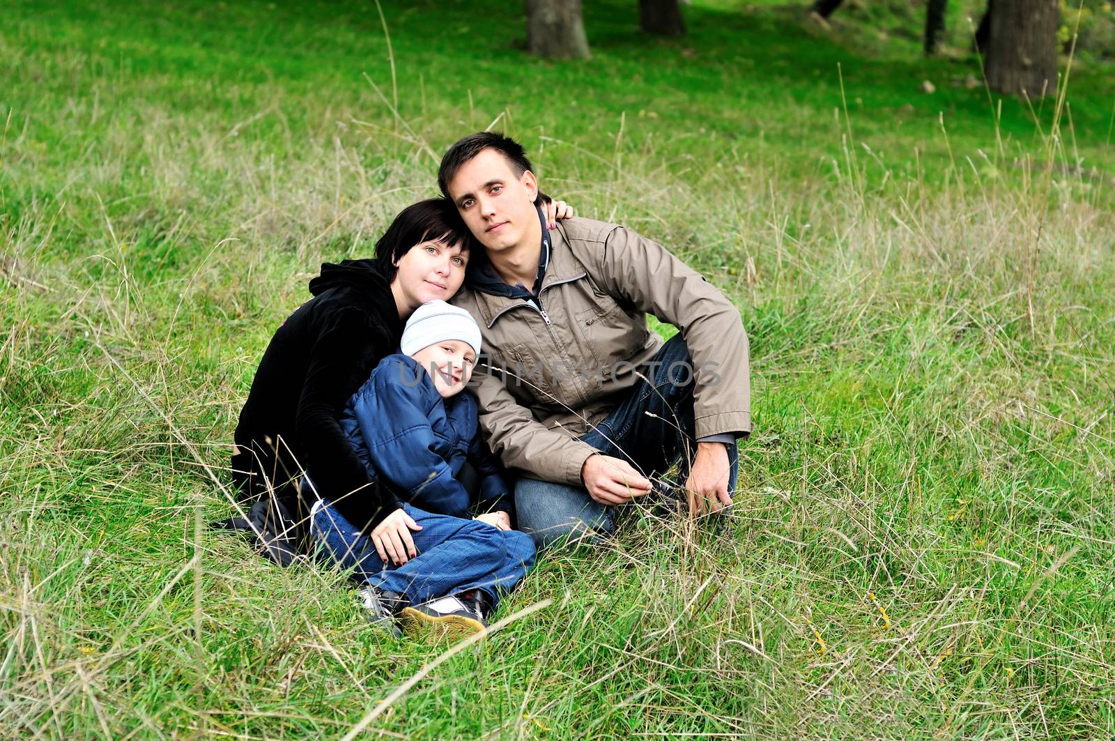 happy family  in the forest during early autumn 