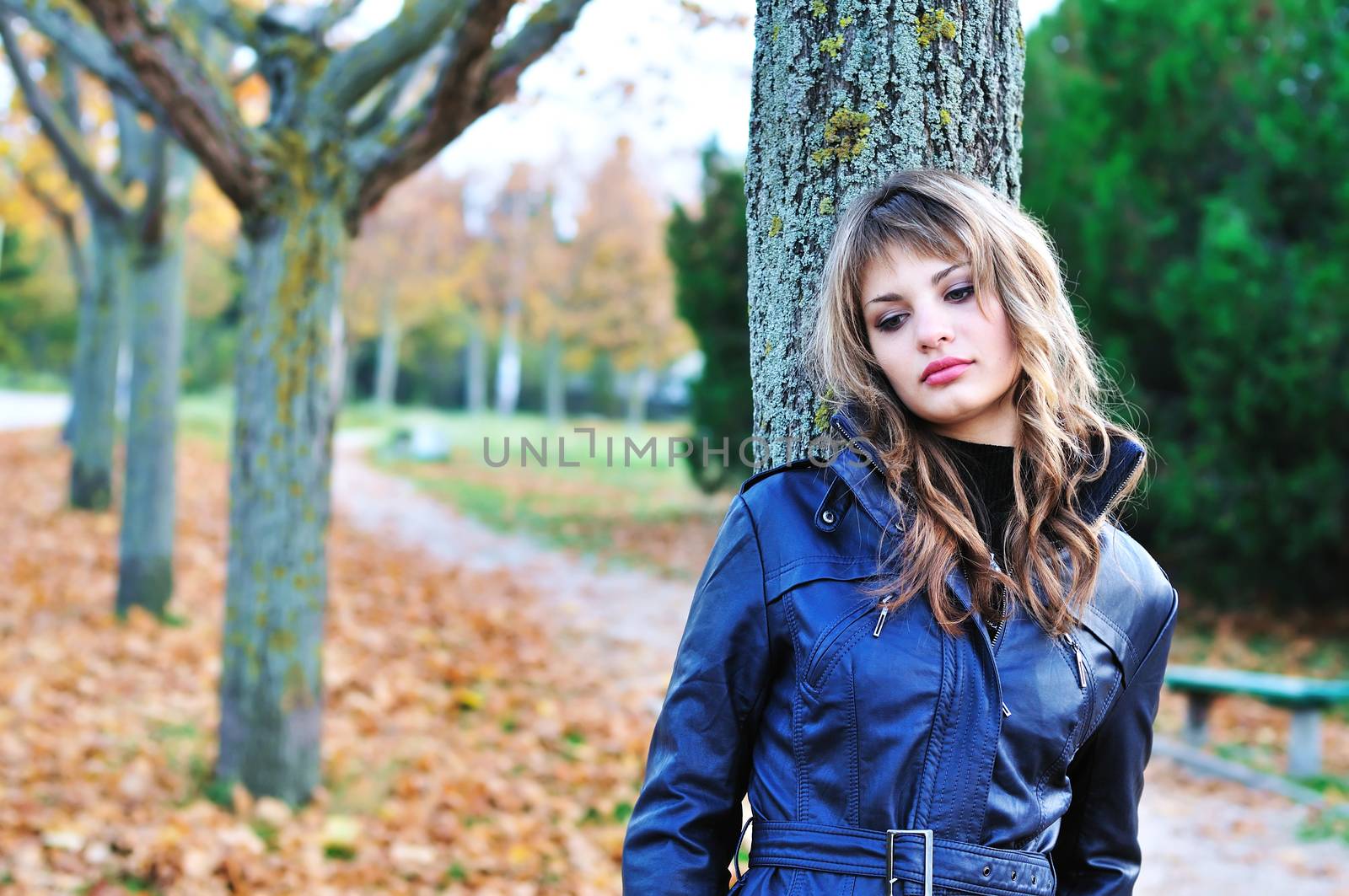 sad teen girl in the autumn park