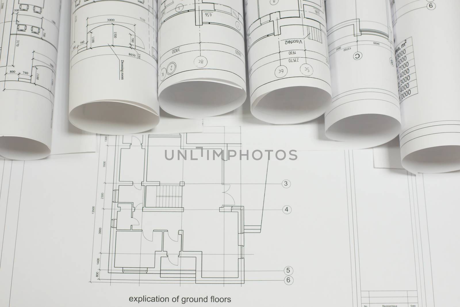 Scrolls architectural drawings on explication of ground floor. Concept of building