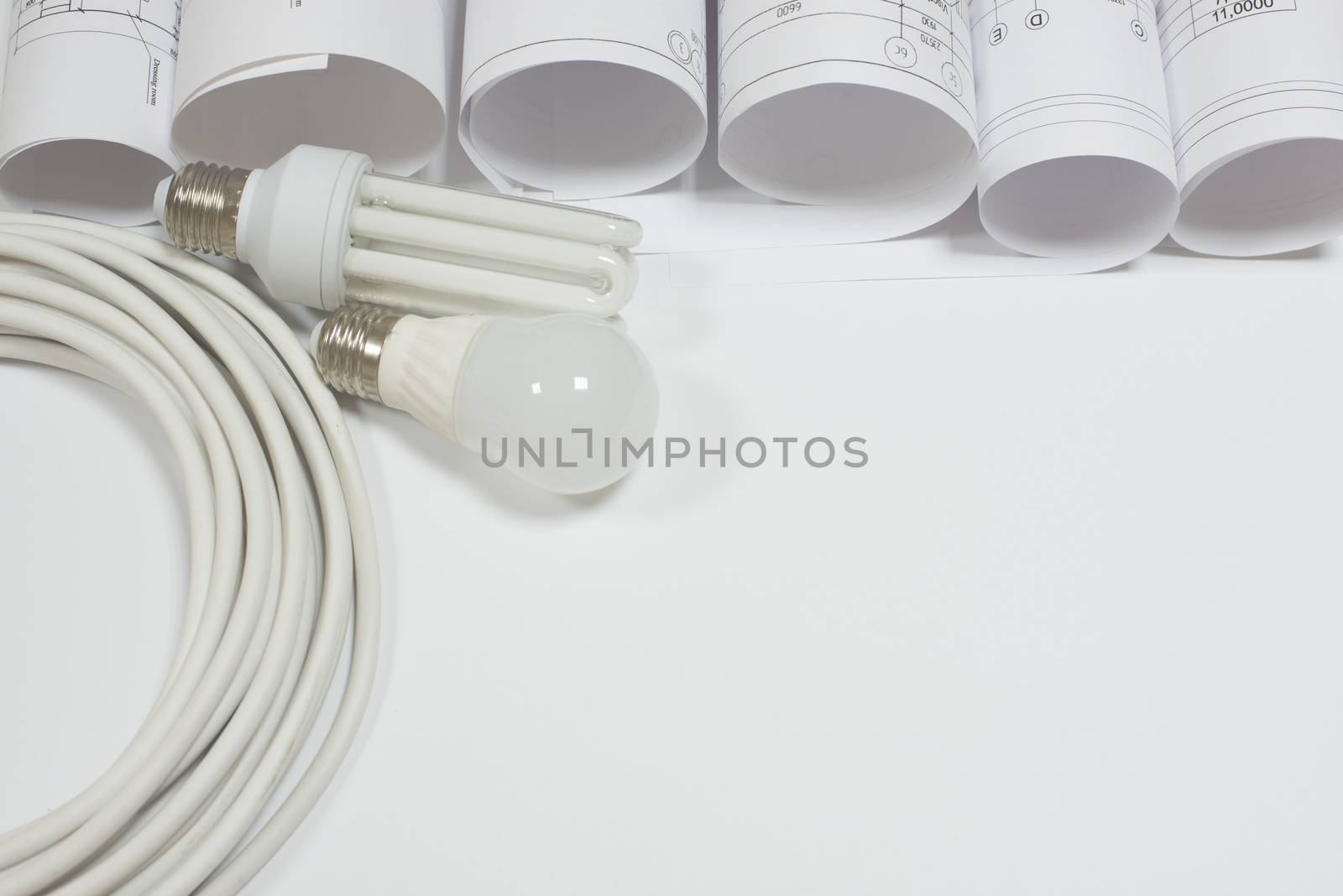 Scrolls architectural drawings with electrical cable and bulbs on white background. Industry concept