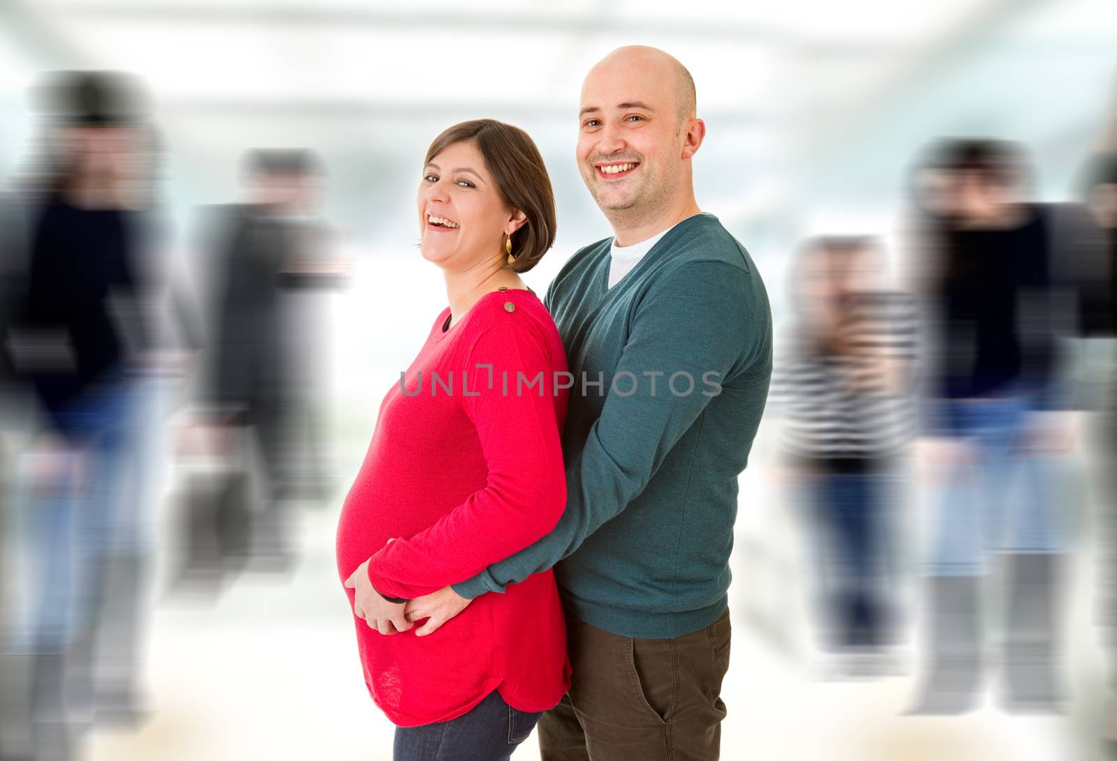 happy pregnant couple posing, studio picture