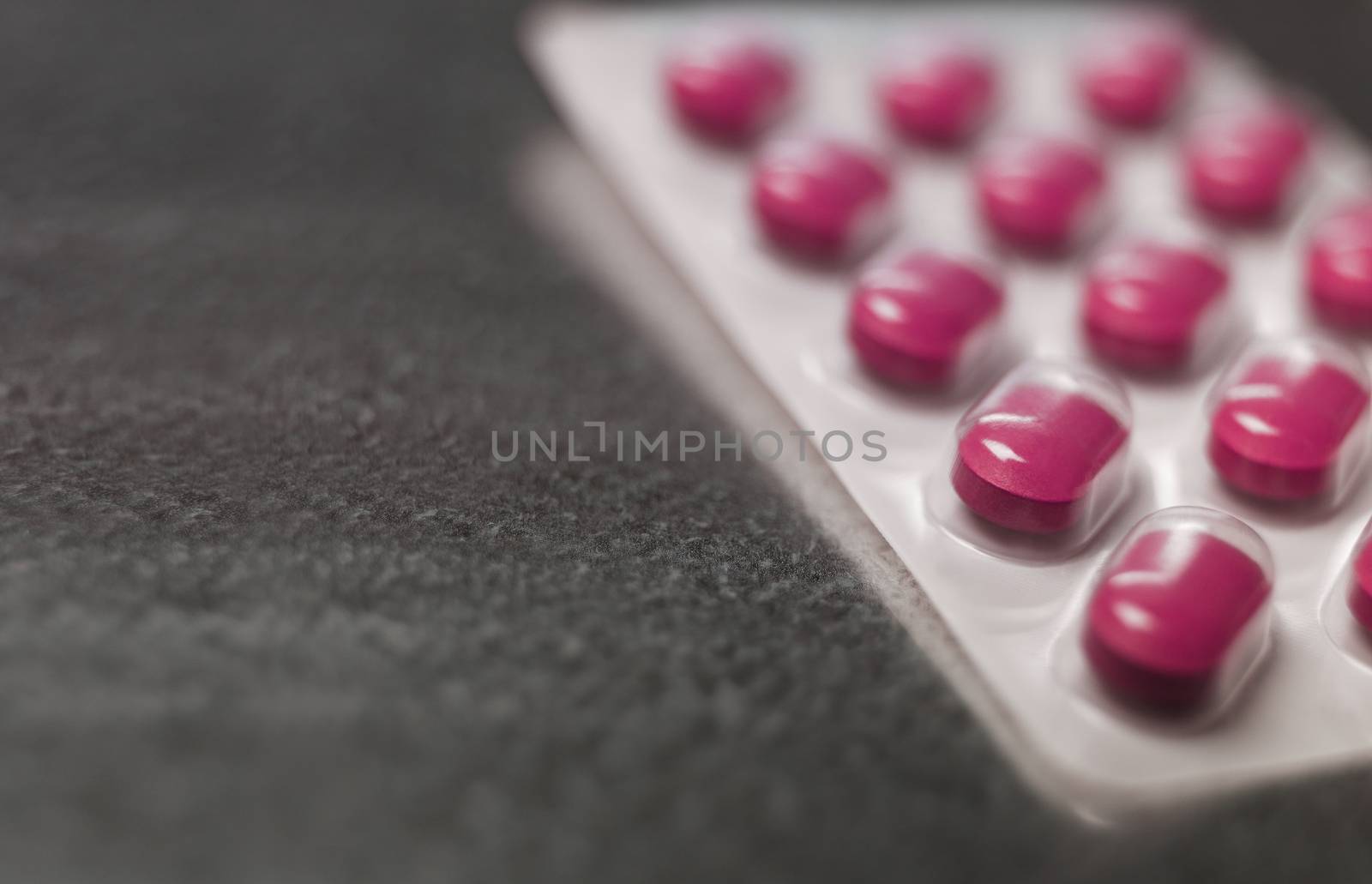Blister pack of Pink medicine pills Close up by gemenacom