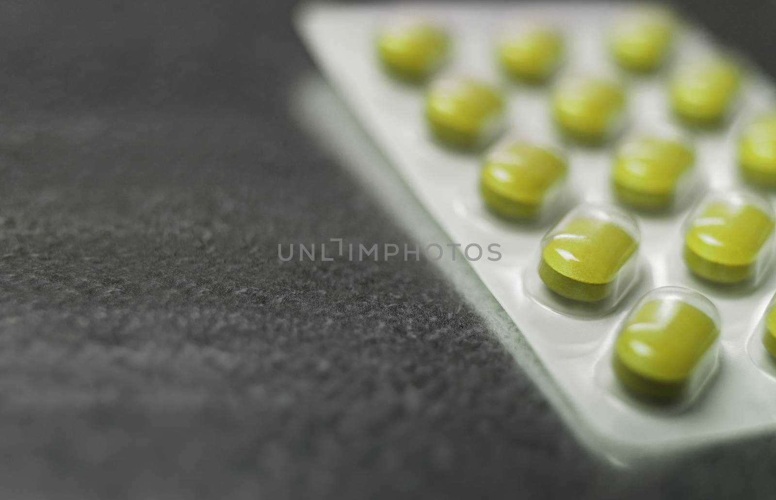 Blister pack of Yellow medicine pills Close up by gemenacom