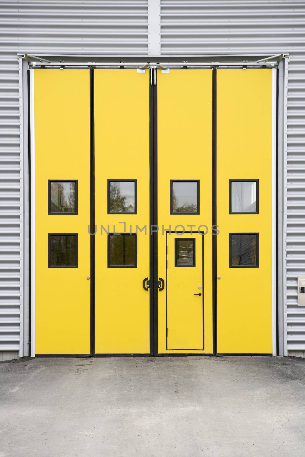 Yellow Garage Door on a warehouse building by gemenacom