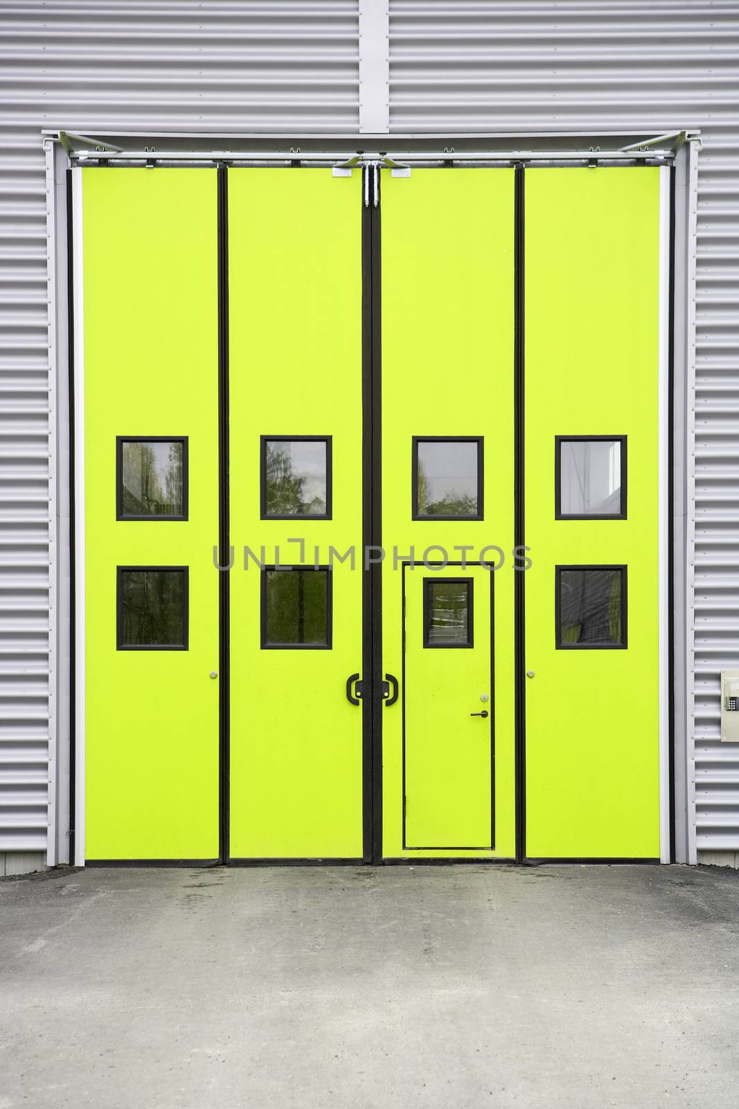 Yellow Garage Door on a warehouse building by gemenacom