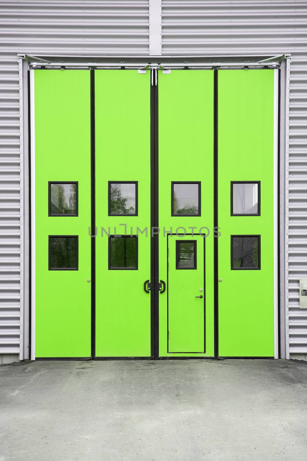Green Garage Door on a warehouse building by gemenacom