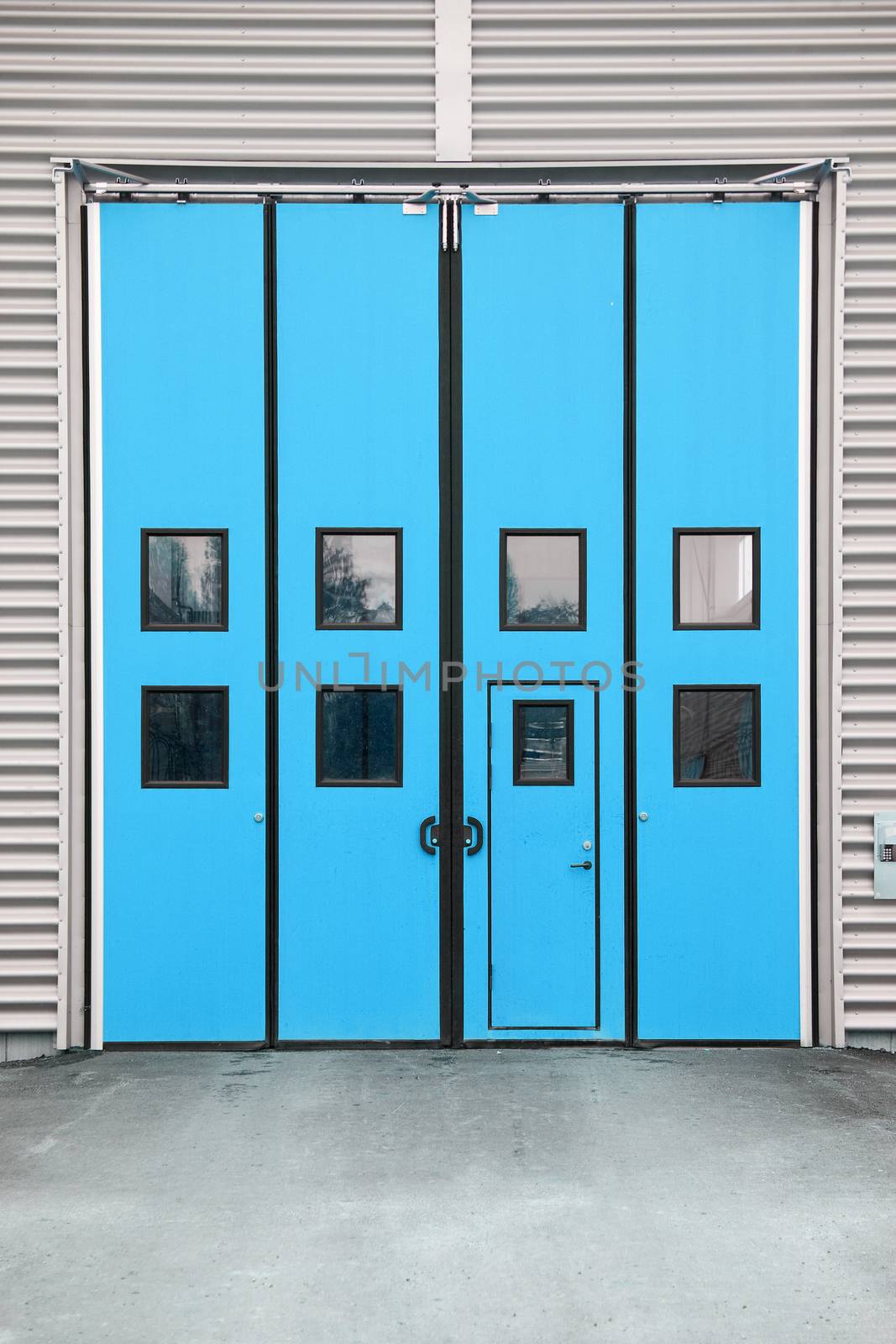Blue Garage Door on a warehouse building by gemenacom