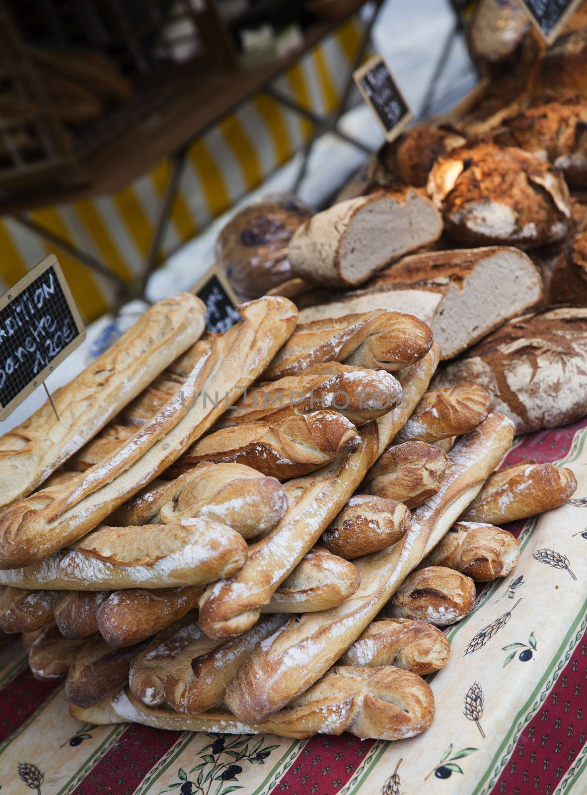 Close up of bread at a market in Paris by gemenacom