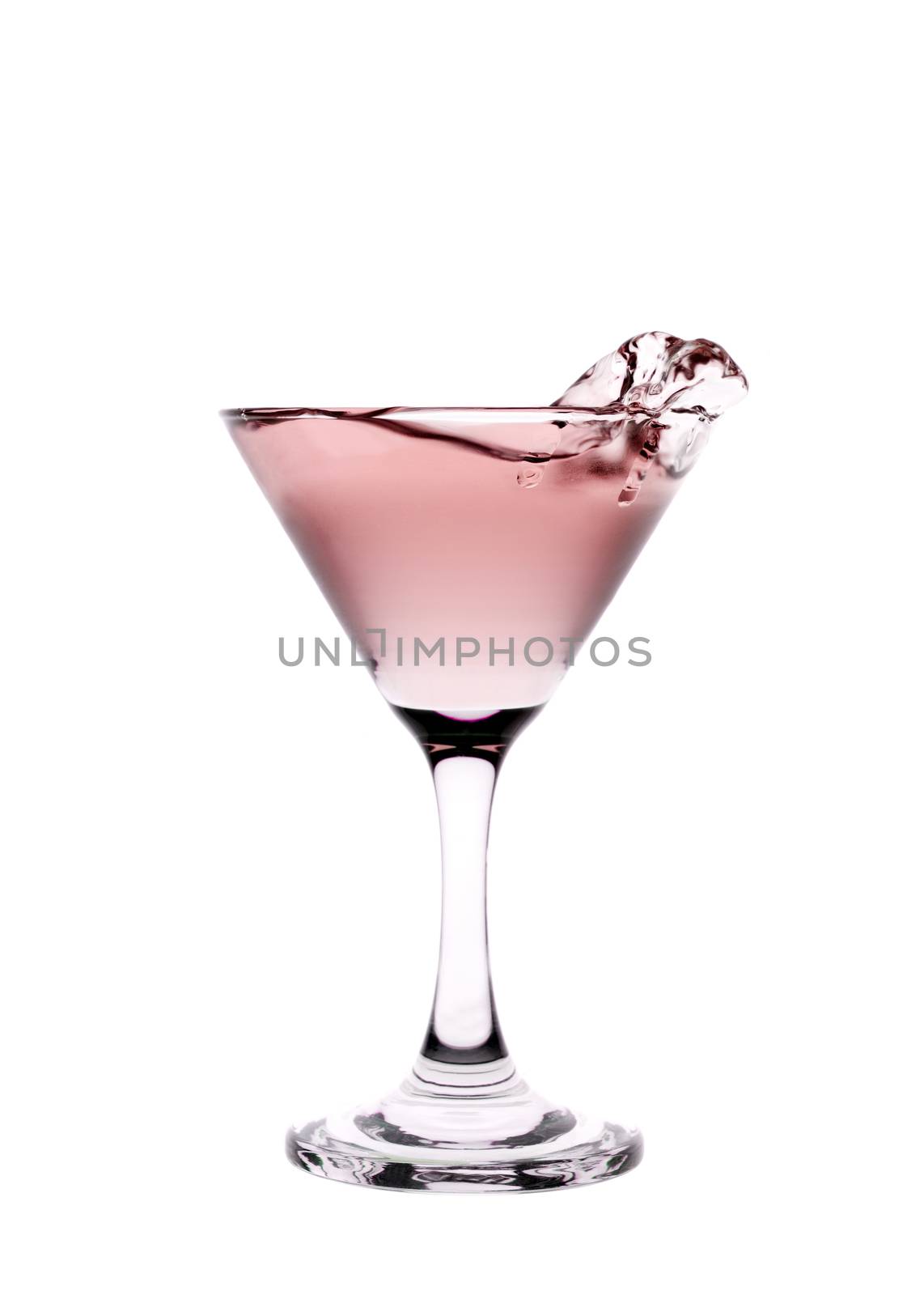 Red liquid splashing in a martini glass isolated on white background