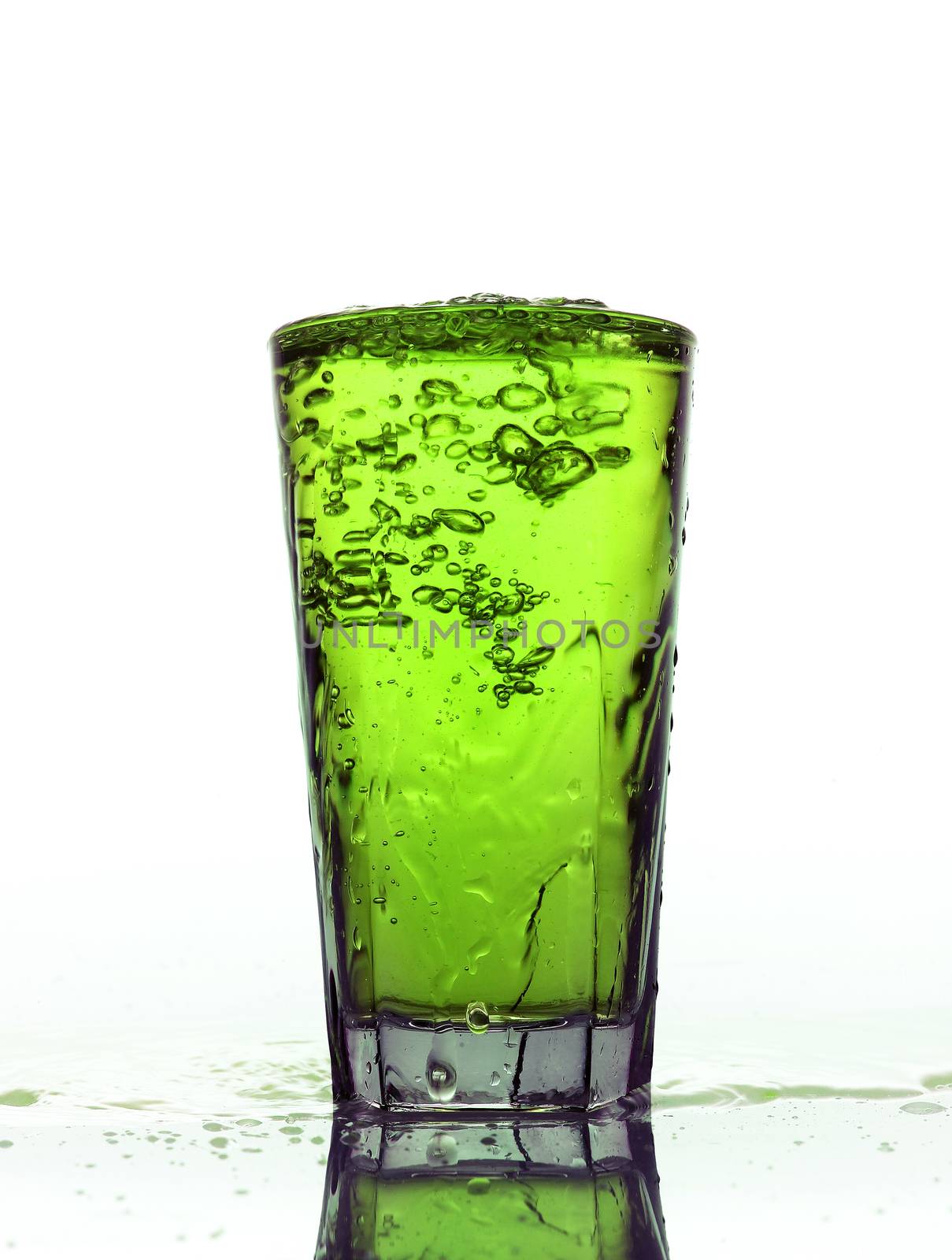 Glass of splashing Green lemonade isolated on white background
