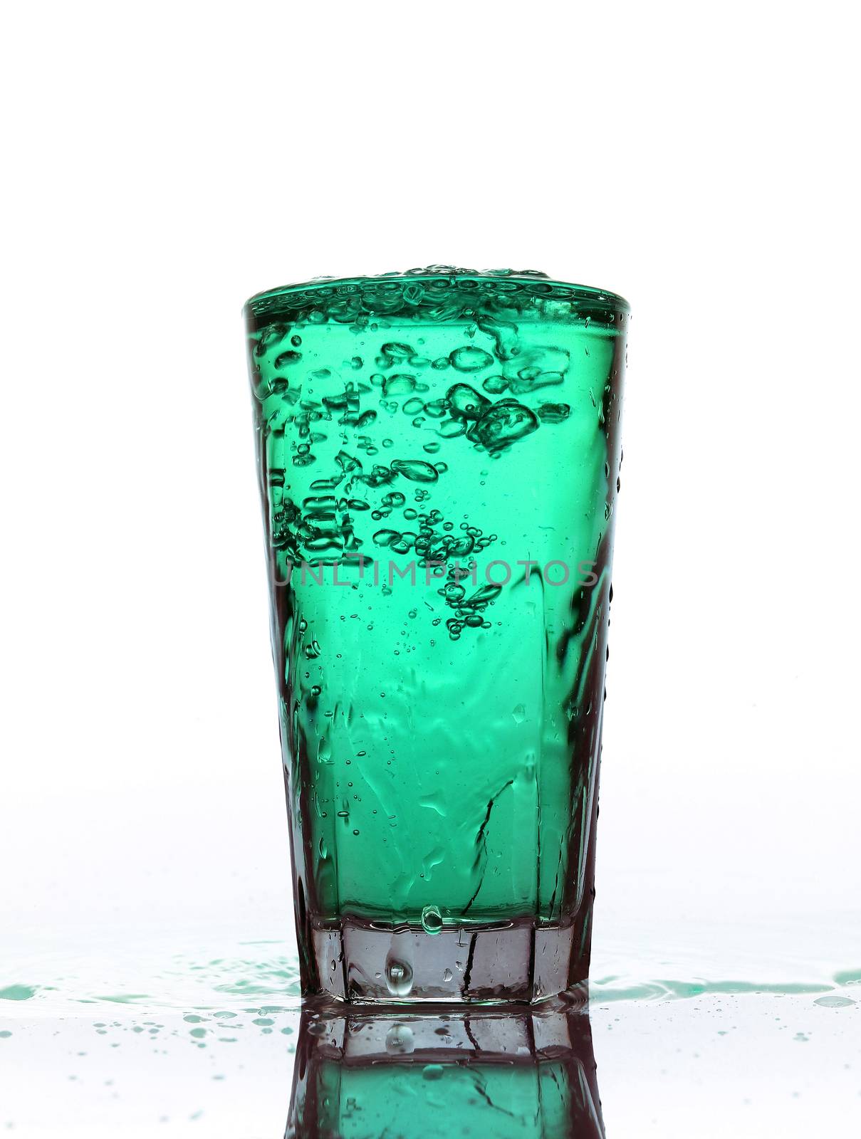 Glass of splashing Turquoise lemonade isolated on white backgrou by gemenacom