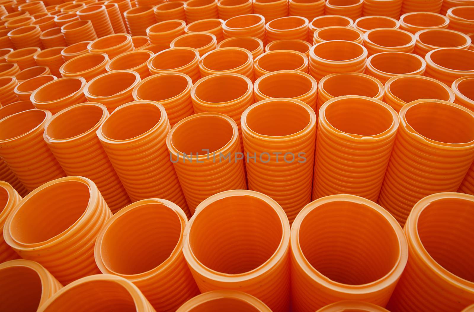 Large Group of Orange Industrial Plastic Pipes Full Frame by gemenacom
