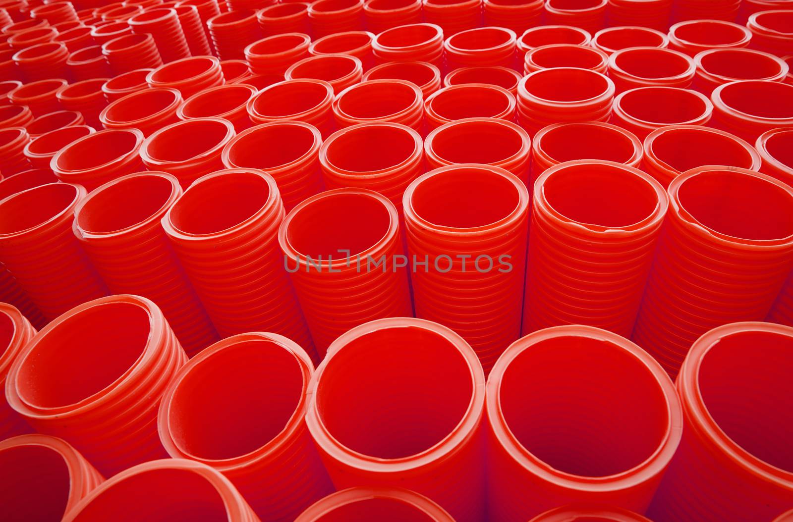 Large Group of Red Industrial Plastic Pipes Full Frame by gemenacom