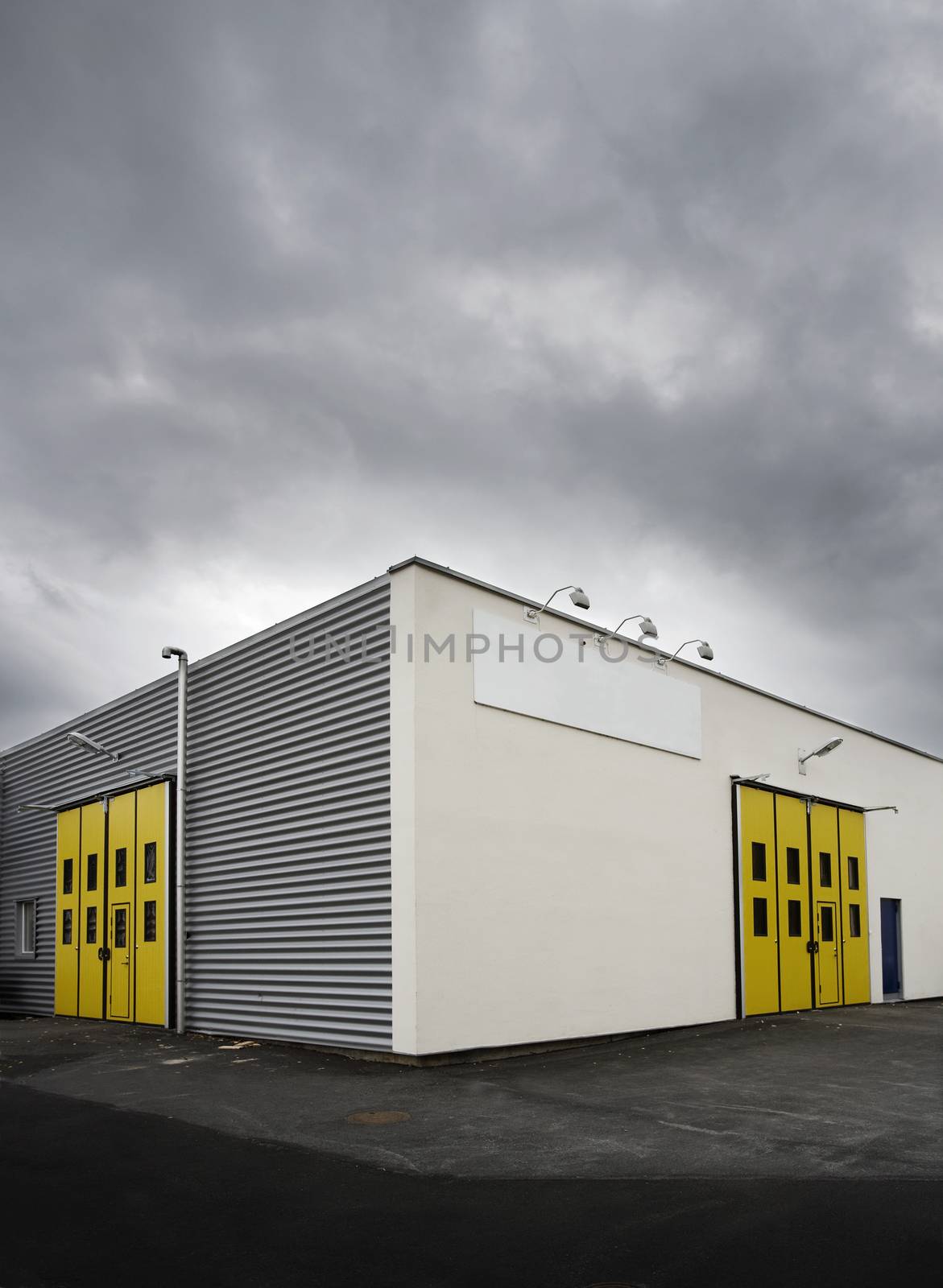 Warehouse with yellow doors at dusk