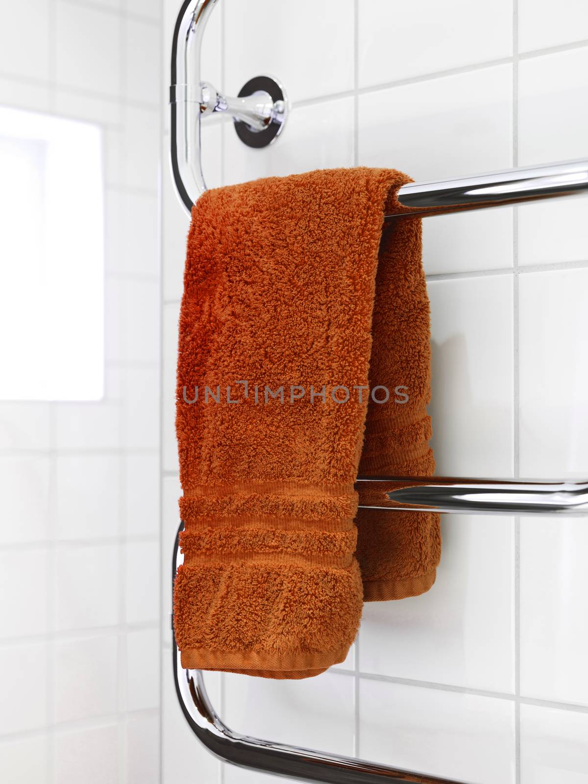 Orange Towel on a dryer in modern bathroom environment