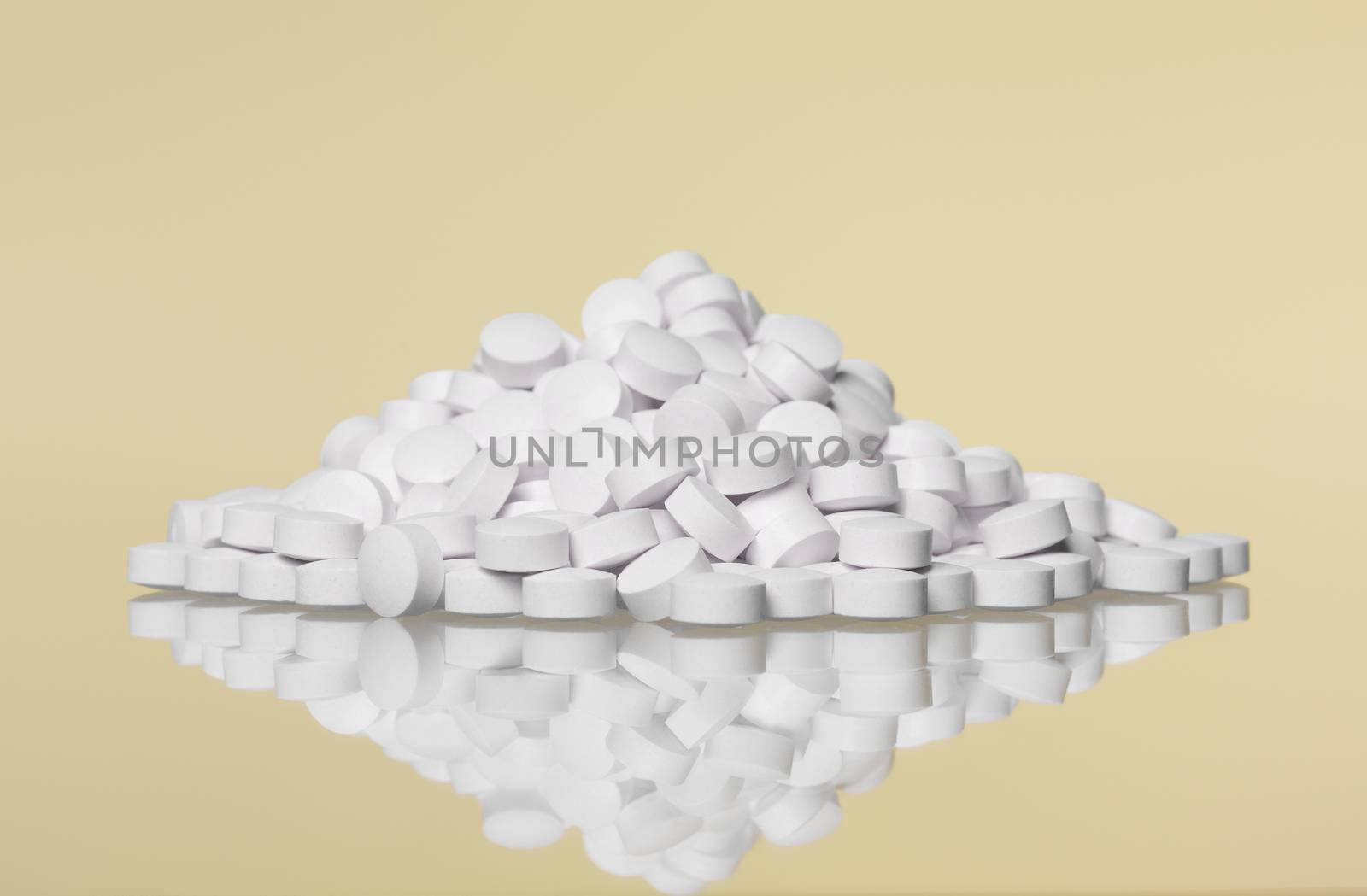 Stack of pills towards Yellow background