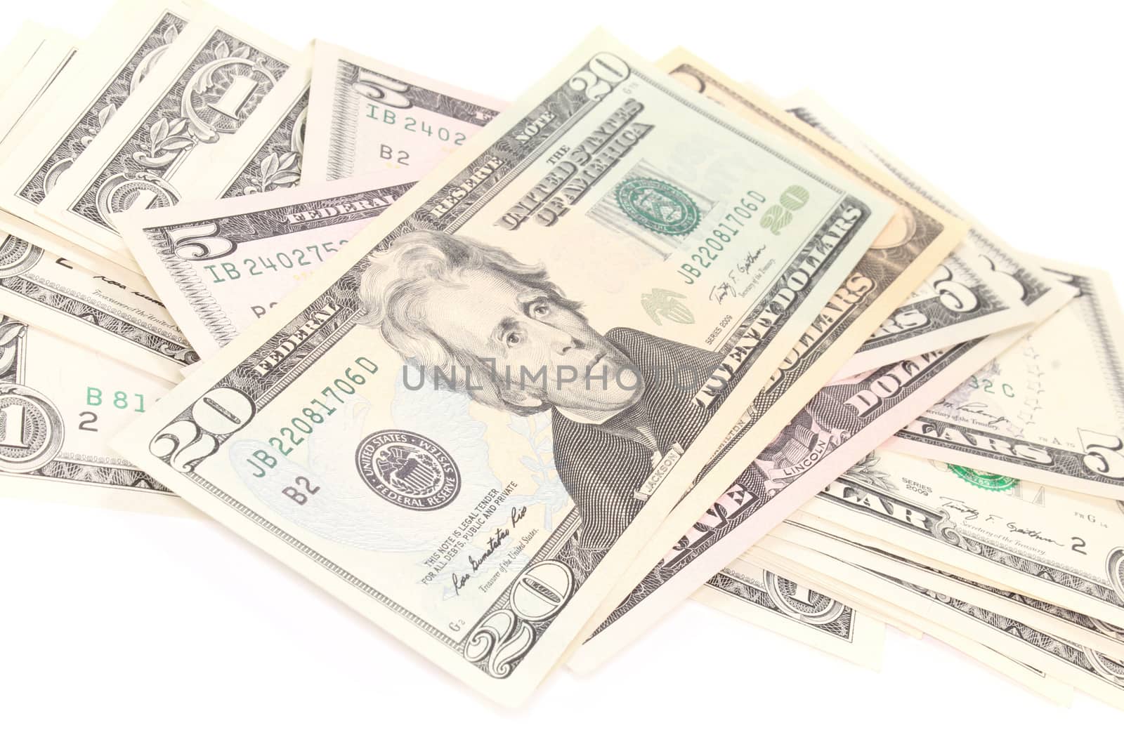 a stack of many colorful dollar bills on white background