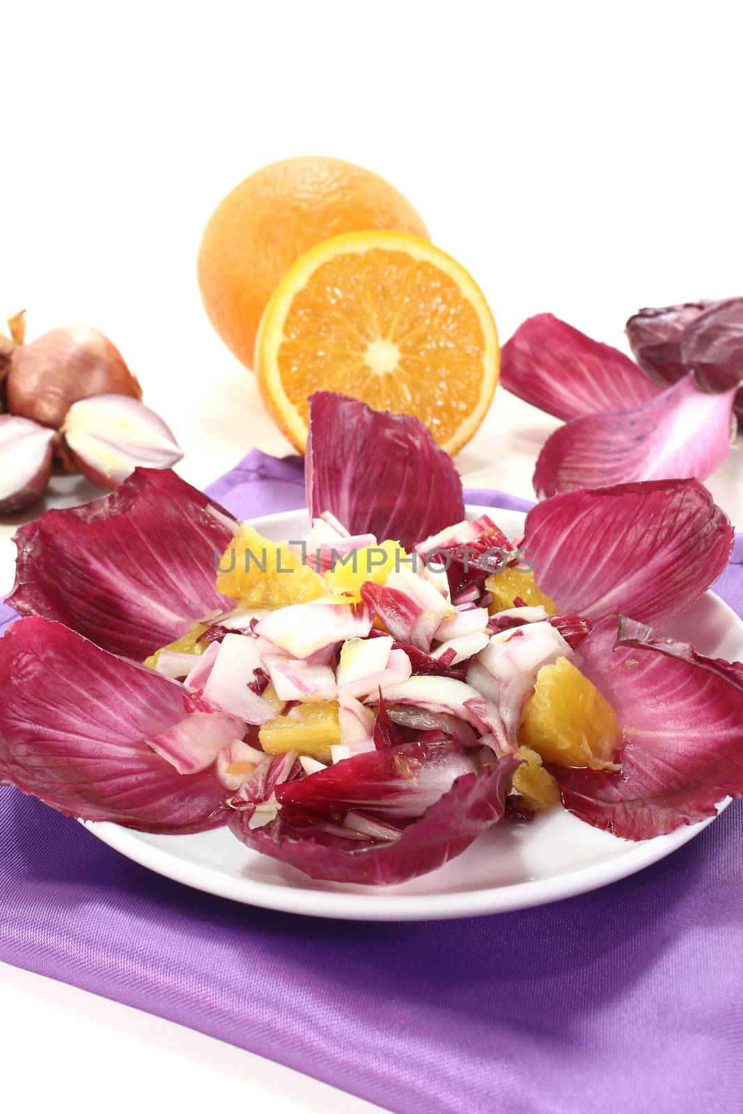 red chicory salad with orange slices and dressing