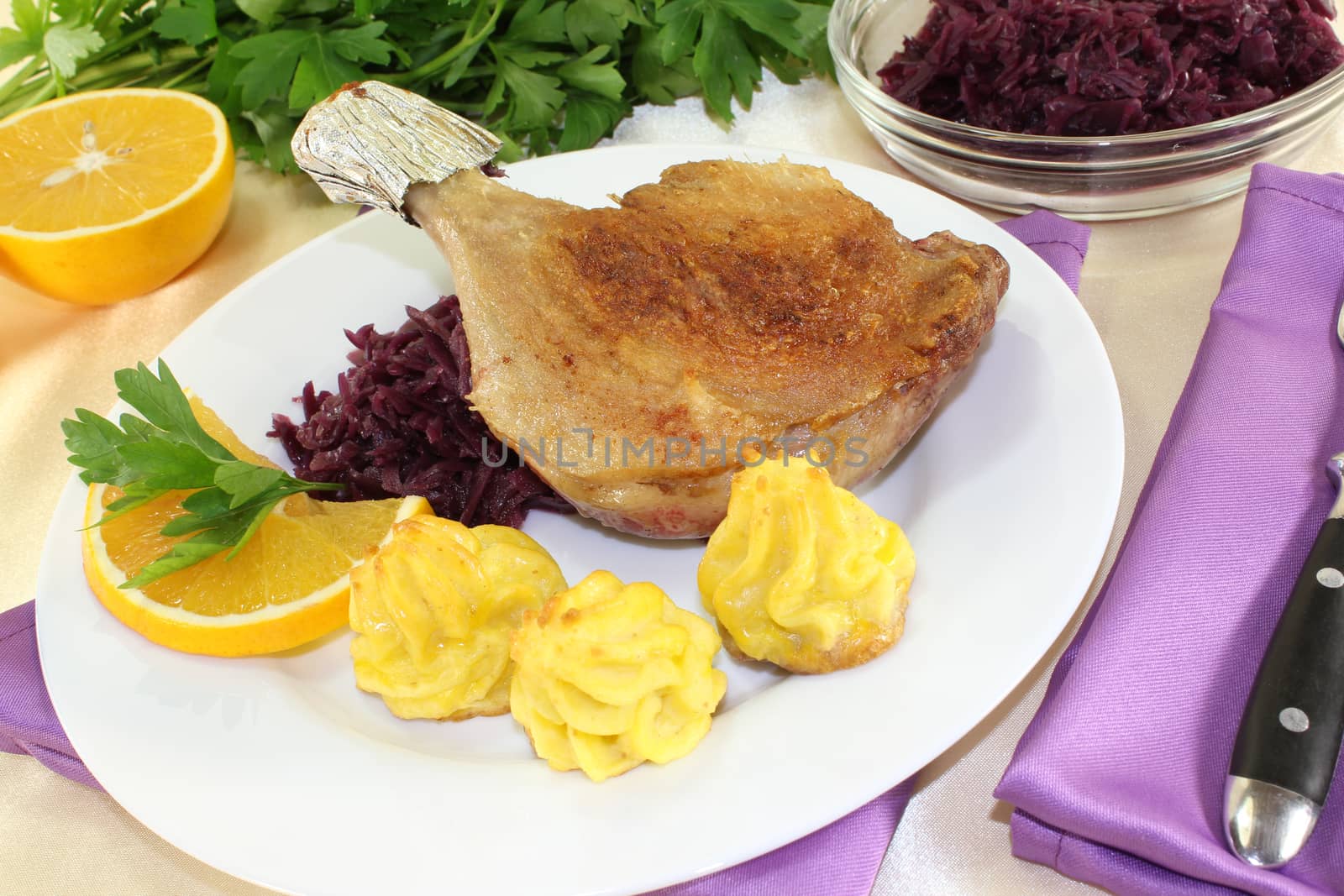 duck drumstick with duchess potatoes and  red cabbage