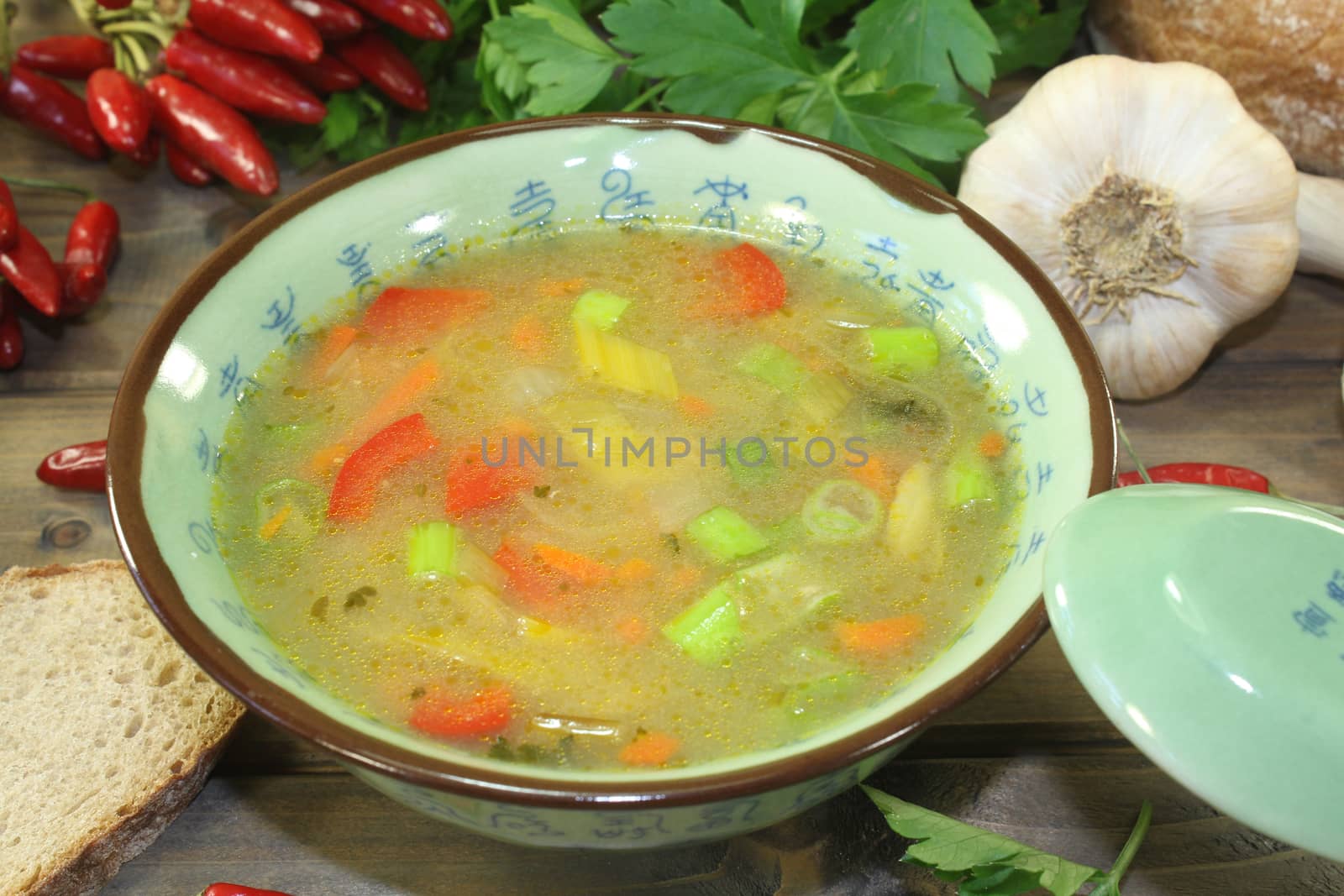 Asian chicken consomme with vegetables and parsley