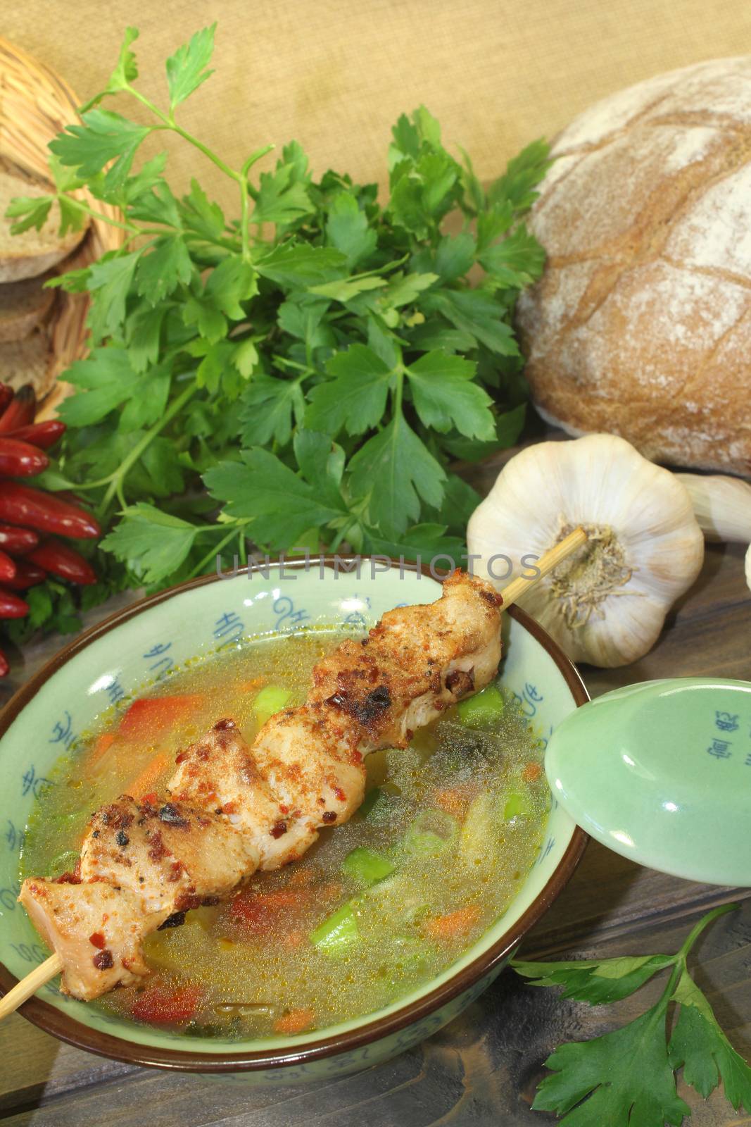 Poultry consomme with chicken skewer by discovery