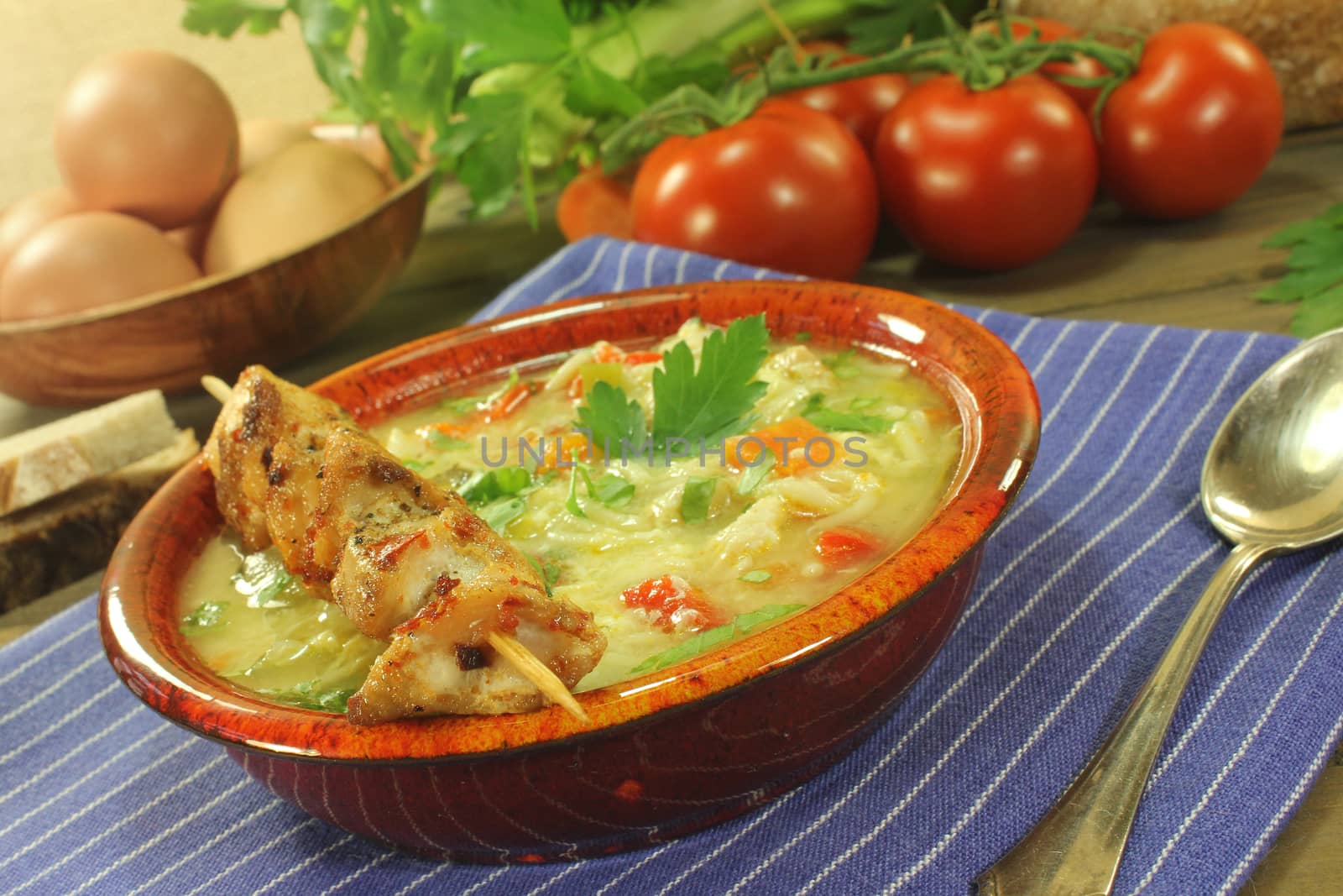 Chicken soup with chicken skewers, bread and noodles by discovery