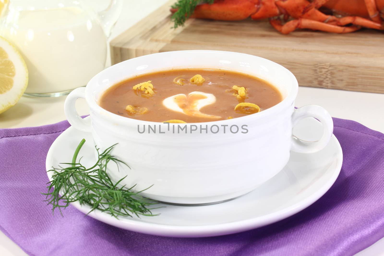 boiled lobster soup with lemon, dill and cream dollop