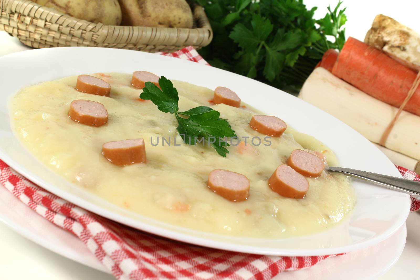 Potato soup with Wiener sausages and flat leaf parsley